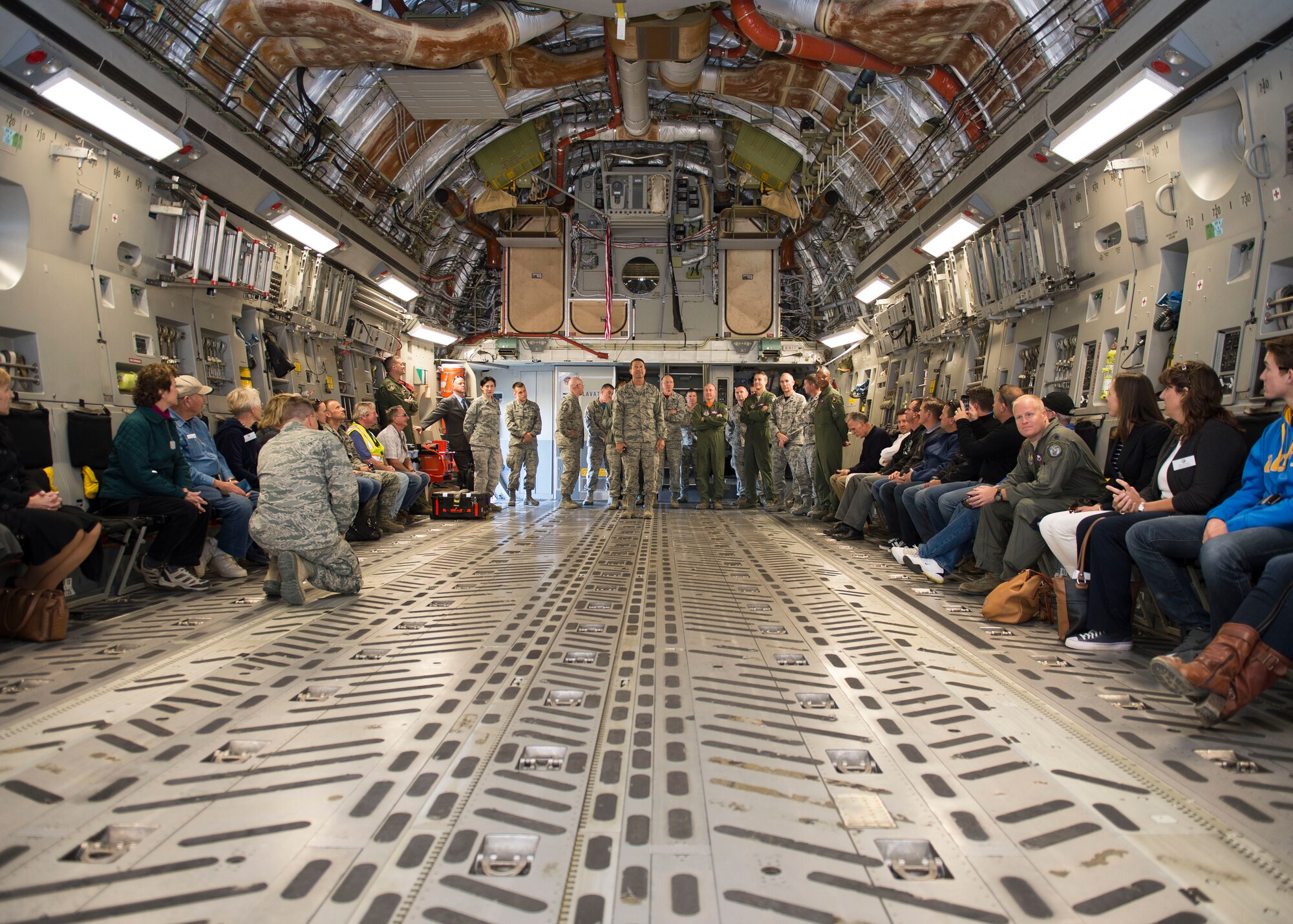 The honorary commander’s simulated deployment ended on a C-17 where they were issued keepsake dog tags. (U.S. Air Force photo by Ethan Wagner)