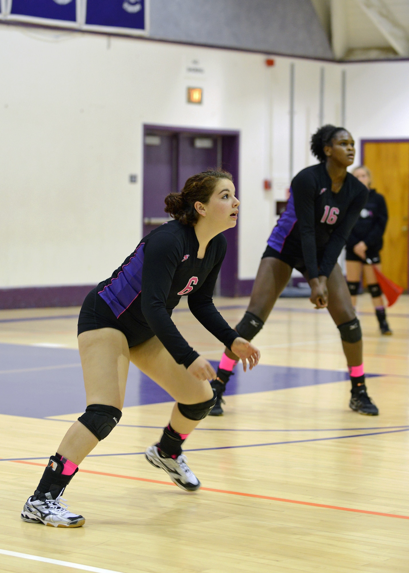 Desert High School varsity volleyball players, April McGee, #6, and Elizabeth Shelton, #16, anticipate a tip from a Mammoth High School hitter during a regular season game Oct. 30 in order to finish with a final league record of 14-0. The team finished with an overall record of 22-2 for the season before entering playoffs. (U.S. Air Force photo by Jet Fabara)