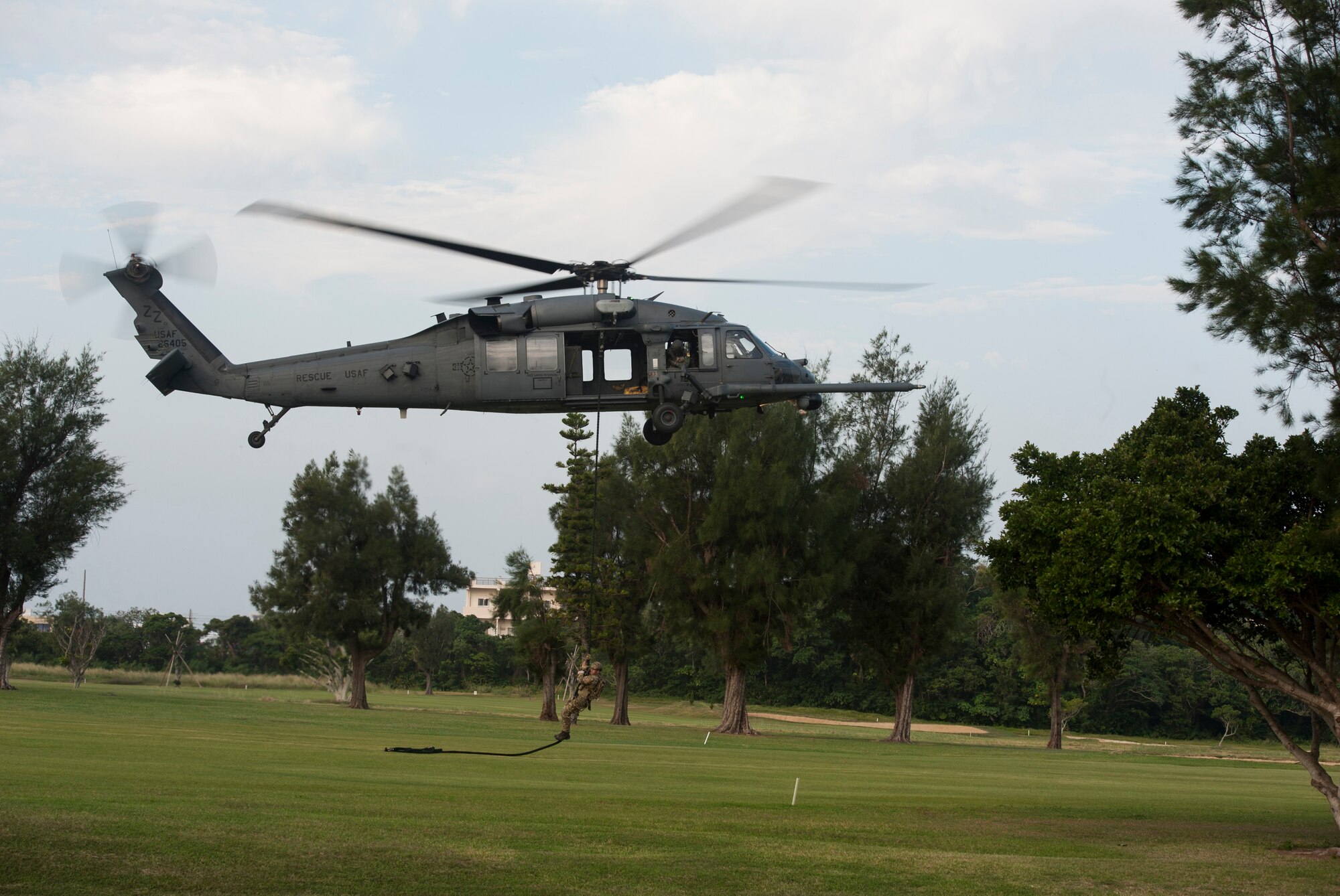 A pararescueman from the 31st Rescue Squadron rappels from an HH-60G Pavehawk assigned to the 33rd Rescue Squadron during a Veterans Day ceremony Nov. 11, 2015, at Kadena Air Base, Japan. The ceremony honored veterans past and present. (U.S. Air Force photo by Airman 1st Class Lynette M. Rolen)