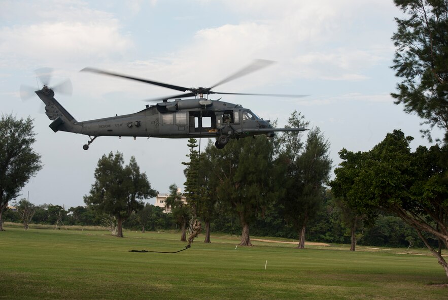 A pararescueman from the 31st Rescue Squadron rappels from an HH-60G Pavehawk assigned to the 33rd Rescue Squadron during a Veterans Day ceremony Nov. 11, 2015, at Kadena Air Base, Japan. The ceremony honored veterans past and present. (U.S. Air Force photo by Airman 1st Class Lynette M. Rolen)