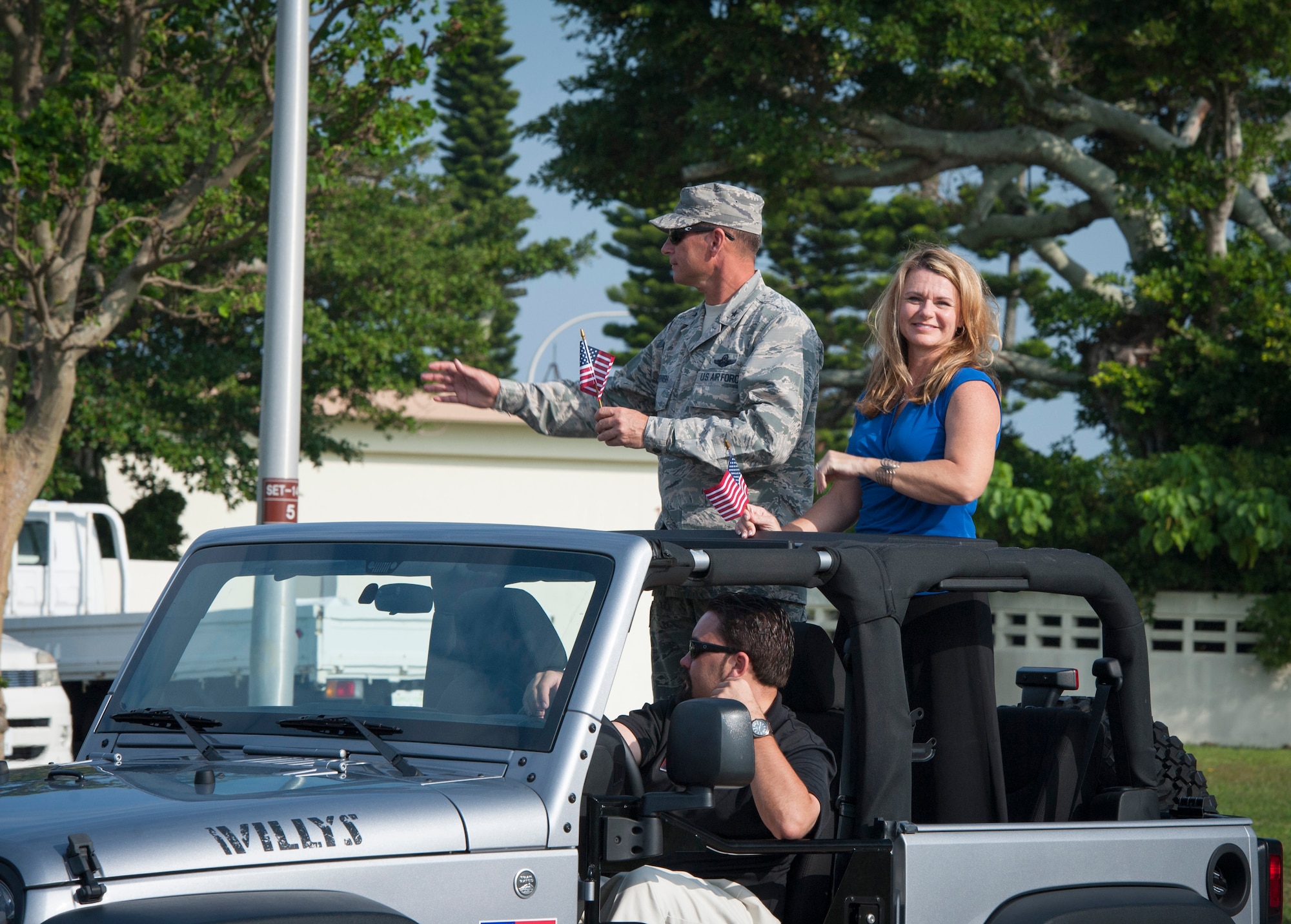 U.S. Air Force Brig. Gen. Barry Cornish, 18th Wing commander, and wife, Missy, wave to attendees of Kadena's first Veterans Day parade Nov. 11, 2015, at Kadena Air Base, Japan. Veterans Day, originally known as Armistice Day, was first observed to commemorate the armistice which went into effect Nov. 11, 1918, and led to the end of World War I. (U.S. Air Force photo by Master Sgt. Jason W. Edwards)