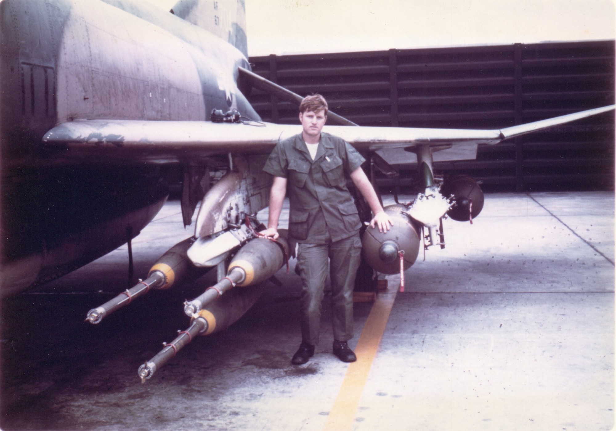 Sgt Ken Coats was a crew chief in the 555th Tactical Fighter Squadron at Udorn Royal Thai AFB from September 1970 to September 1971.  He is pictured here with F-4D 66-7704 loaded with Mk 82 500-lb bombs with fuze extenders and cluster bombs, ready for a mission over Laos. (Courtesy Ken Coats)