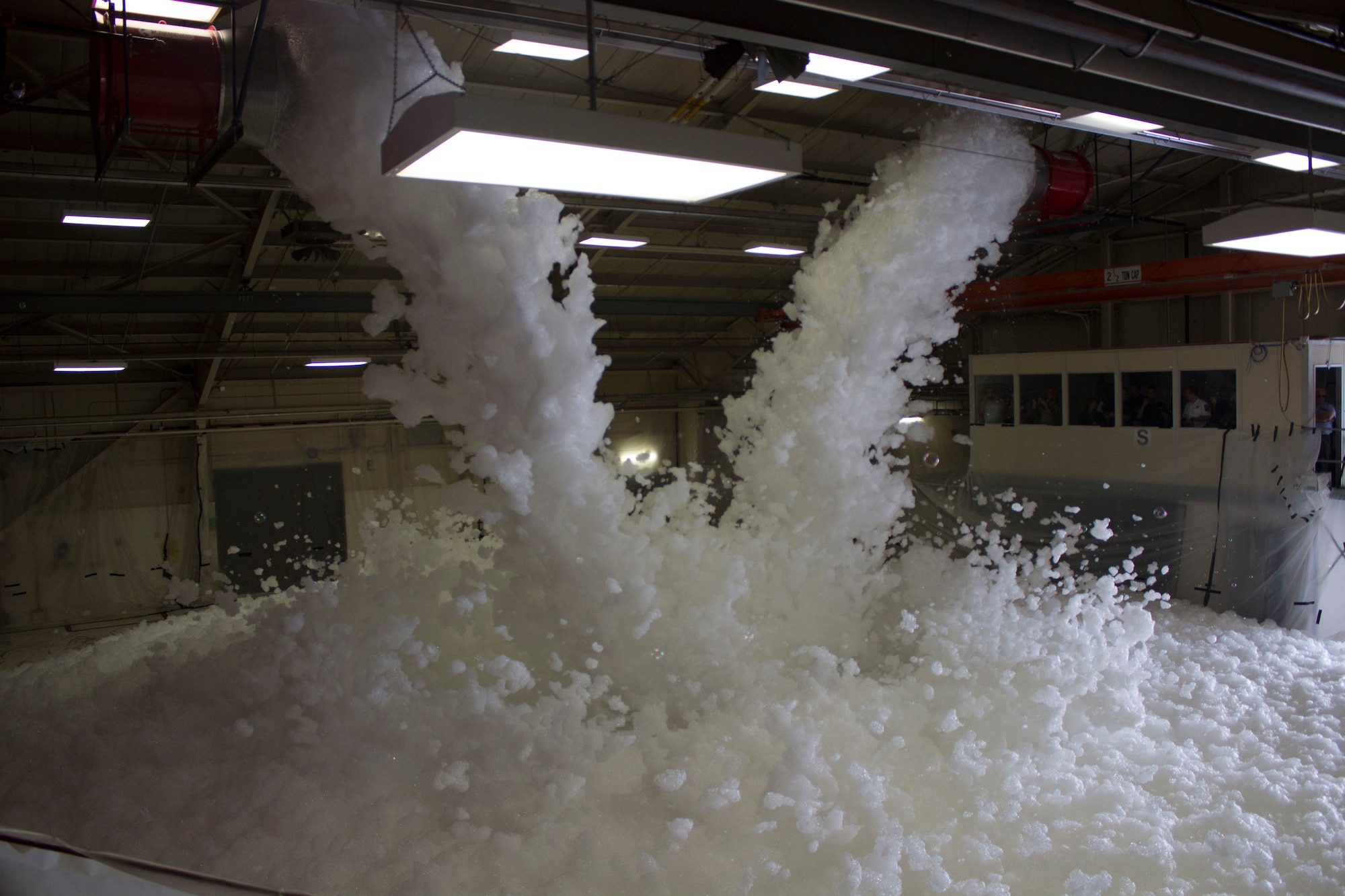 Flowing foam is a vital part of the final acceptance test to ensure hangar fire suppression systems meet performance requirements to protect aircraft. (U.S. Air Force Photo/Susan Lawson/Released)