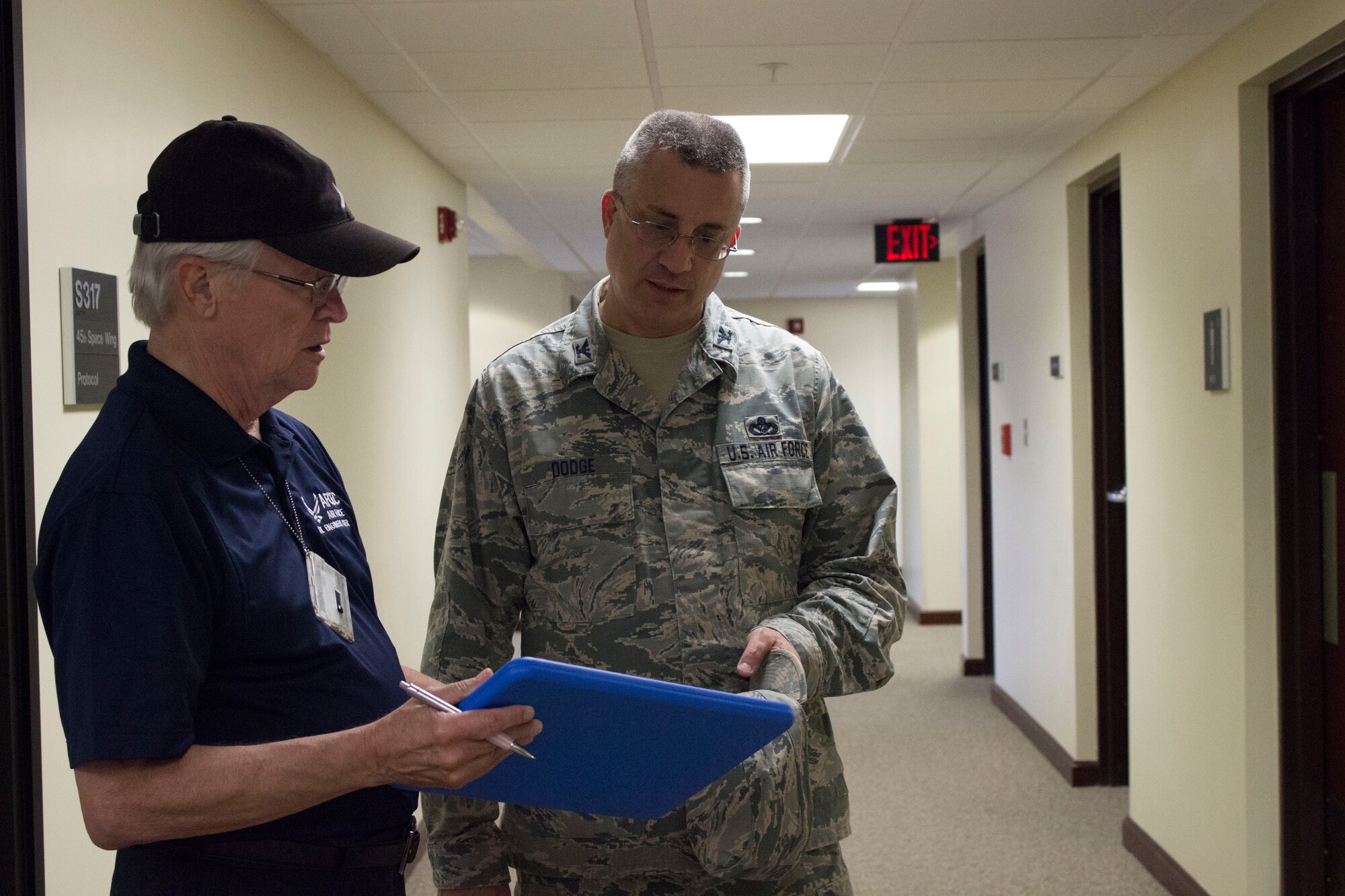 Col. Timothy Dodge, director of the Air Force Civil Engineer Center Operations Directorate, and Edwin “Ed” Bartlett, Jr., electrical engineer and AFCEC asset visibility team member, discuss opportunities for energy savings during a recent visit to Patrick Air Force Base, Florida. (U.S. Air Force Photo/Susan Lawson/Released)