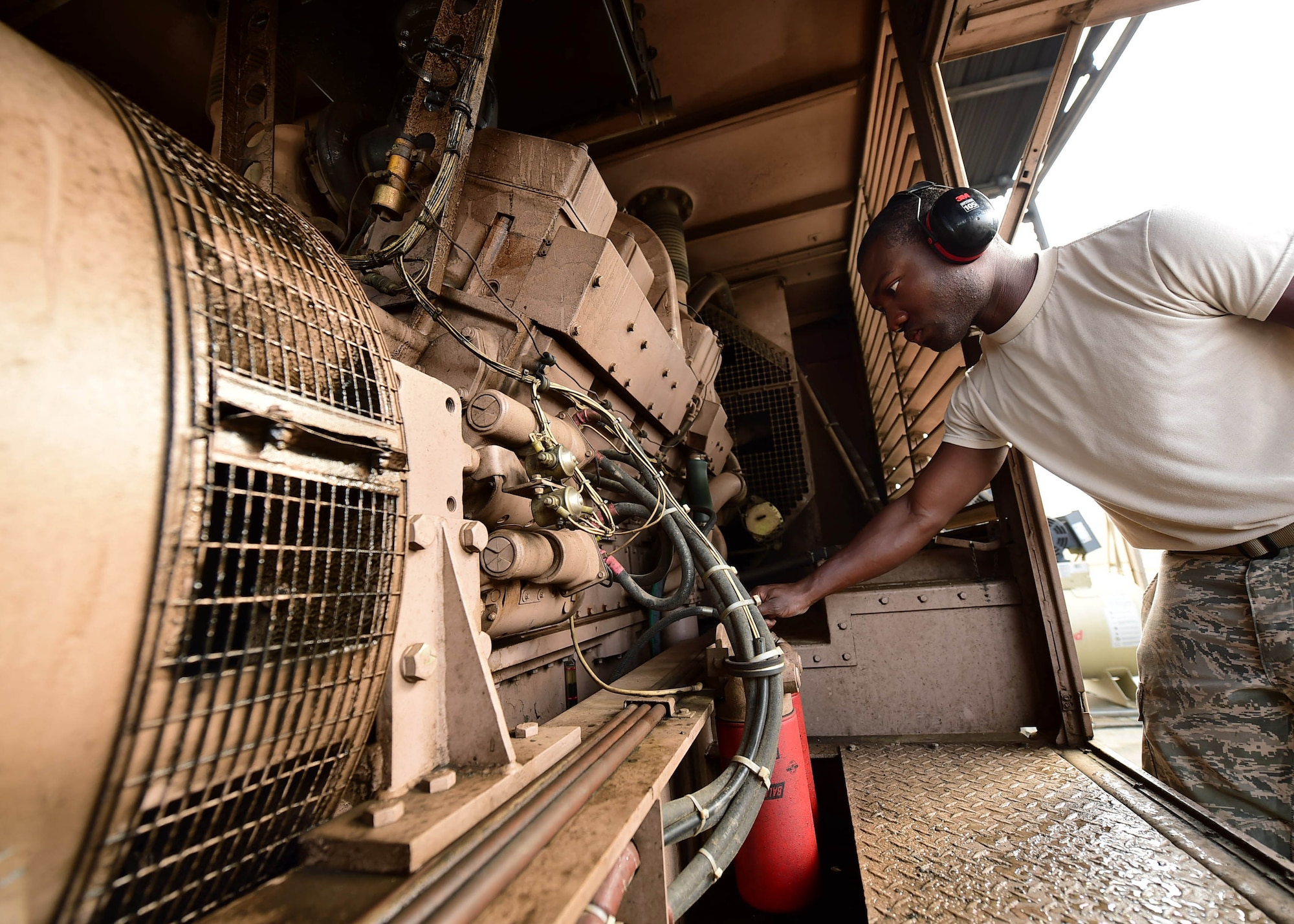 Airman 1st Class Timouy Brown, a 386th Expeditionary Civil Engineer Squadron electrical power production journeyman, performs a pre-operations check on a generator at an undisclosed location in Southwest Asia, Nov. 6, 2015. Standard operations checks are performed before a generator is turned on to ensure it is working correctly and to mitigate generator mishaps. (U.S. Air Force photo by Staff Sgt. Jerilyn Quintanilla)