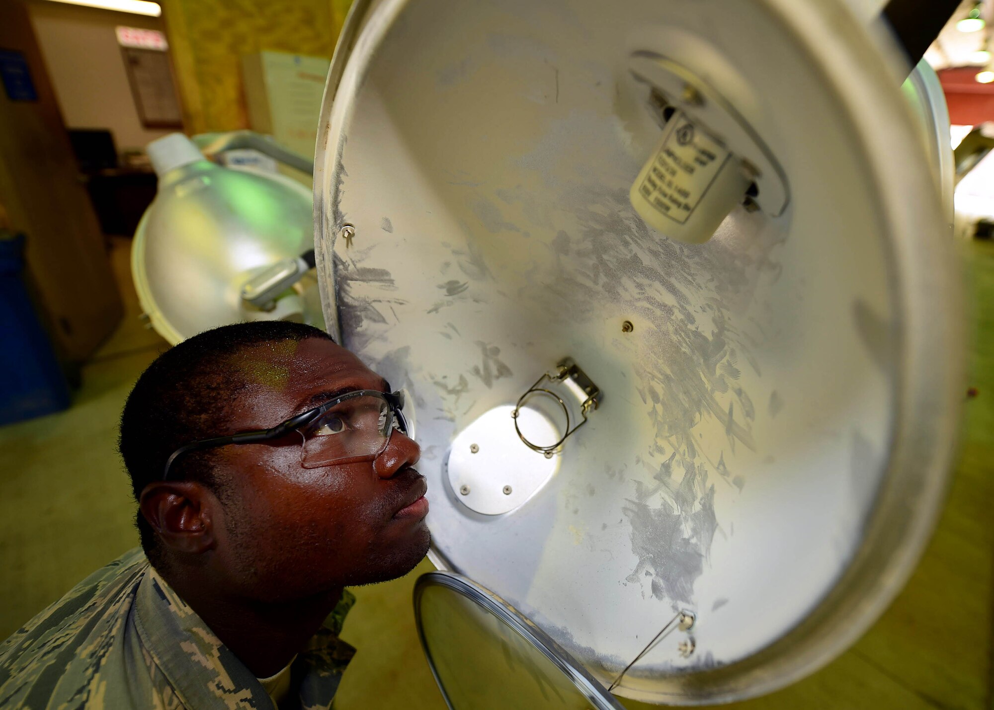 Airman 1st Class Timouy Brown, a 386th Expeditionary Civil Engineer Squadron electrical power production journeyman, inspects a broken light cart fixture at an undisclosed location in Southwest Asia, Nov. 6, 2015. Mobile light carts are used throughout the installation and on the flight line to supplement stationary light sources in hours of darkness. (U.S. Air Force photo by Staff Sgt. Jerilyn Quintanilla)