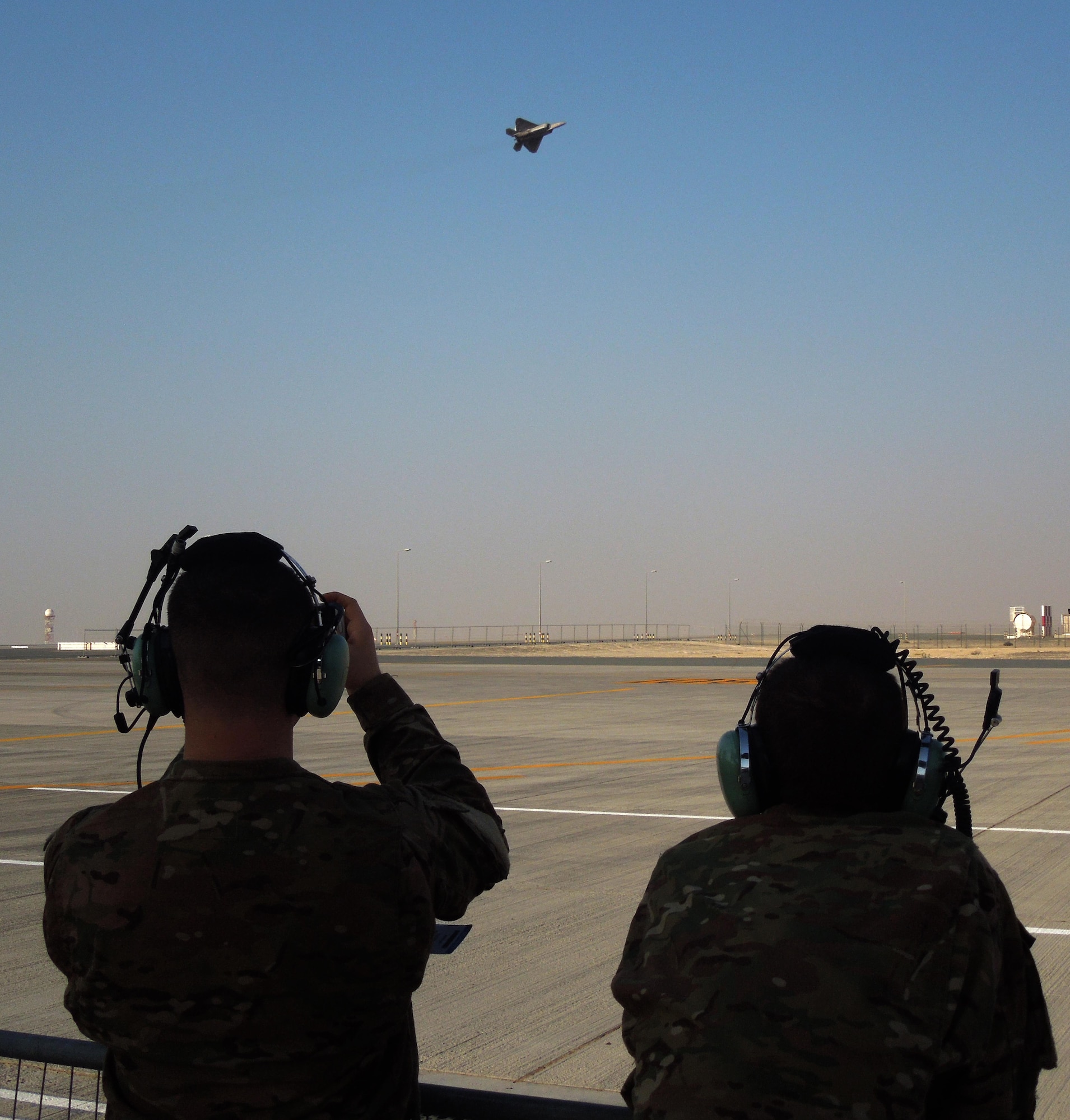 Members of the 455th Expeditionary Maintenance Squadron, Bagram Air Field, Afghanistan, watch as an F-22 Raptor, performs at the 2015 Dubai Air Show, United Arab Emirates, Nov. 9, 2015. The air show is considered to be the premier aviation and air industry event in the Middle East region. (U.S. Air Force photo by Tech. Sgt. Joshua Strang)