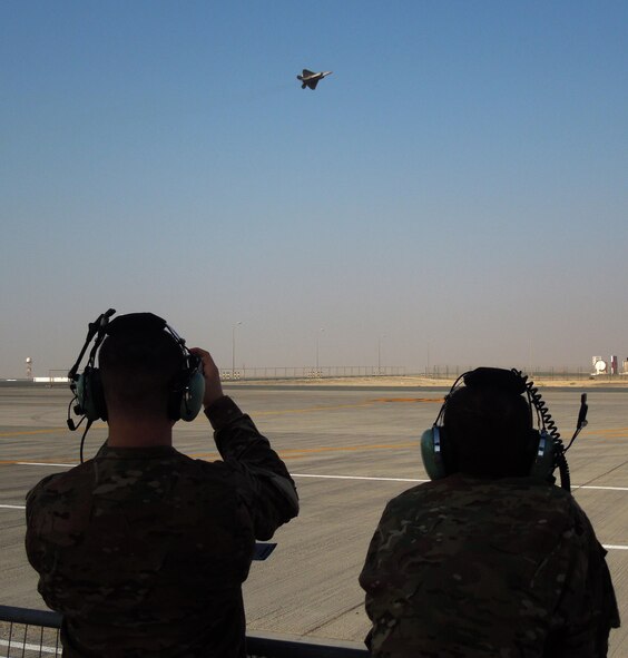 Members of the 455th Expeditionary Maintenance Squadron, Bagram Air Field, Afghanistan, watch as an F-22 Raptor, performs at the 2015 Dubai Air Show, United Arab Emirates, Nov. 9, 2015. The air show is considered to be the premier aviation and air industry event in the Middle East region. (U.S. Air Force photo by Tech. Sgt. Joshua Strang)