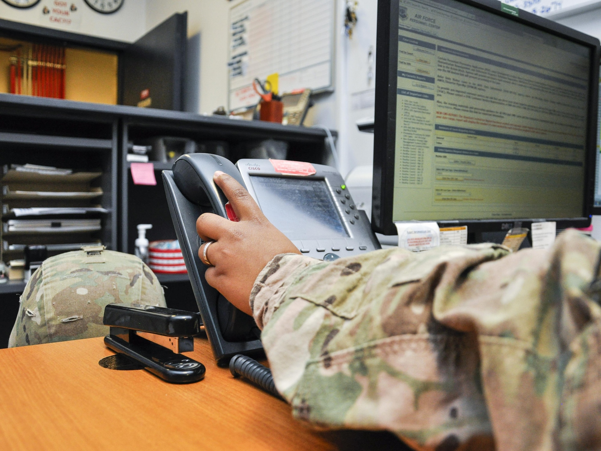 Airman 1st Class Kyla Holmes, Personnel Support of Contingency Operations sustainment team member with the 455th Expeditionary Force Support Squadron, answers the phone at Bagram Airfield, Afghanistan, on Nov. 11, 2015. The small Bagram PERSCO team of only nine members manages nearly 4,000 personnel and is responsible for the accurate accountability and movement of all of them. (U.S. Air Force photo by Tech. Sgt. Nicholas Rau/Released)