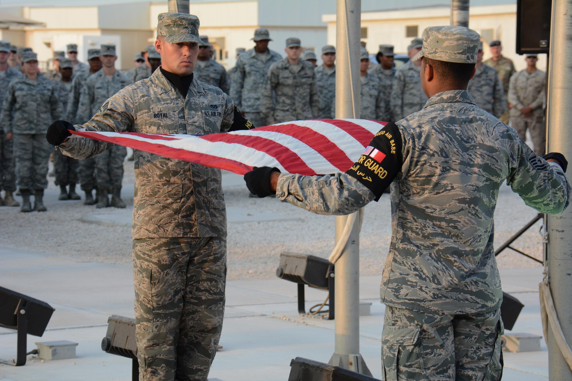 Members of the Al Udeid Air Base, Qatar Honor Guard fold the U.S. flag during a retreat ceremony at the base Nov. 11 in observance of Veterans Day. The retreat ceremony was held to honor America's veterans past and present. (U.S. Air Force photo by Tech. Sgt. James Hodgman/Released)