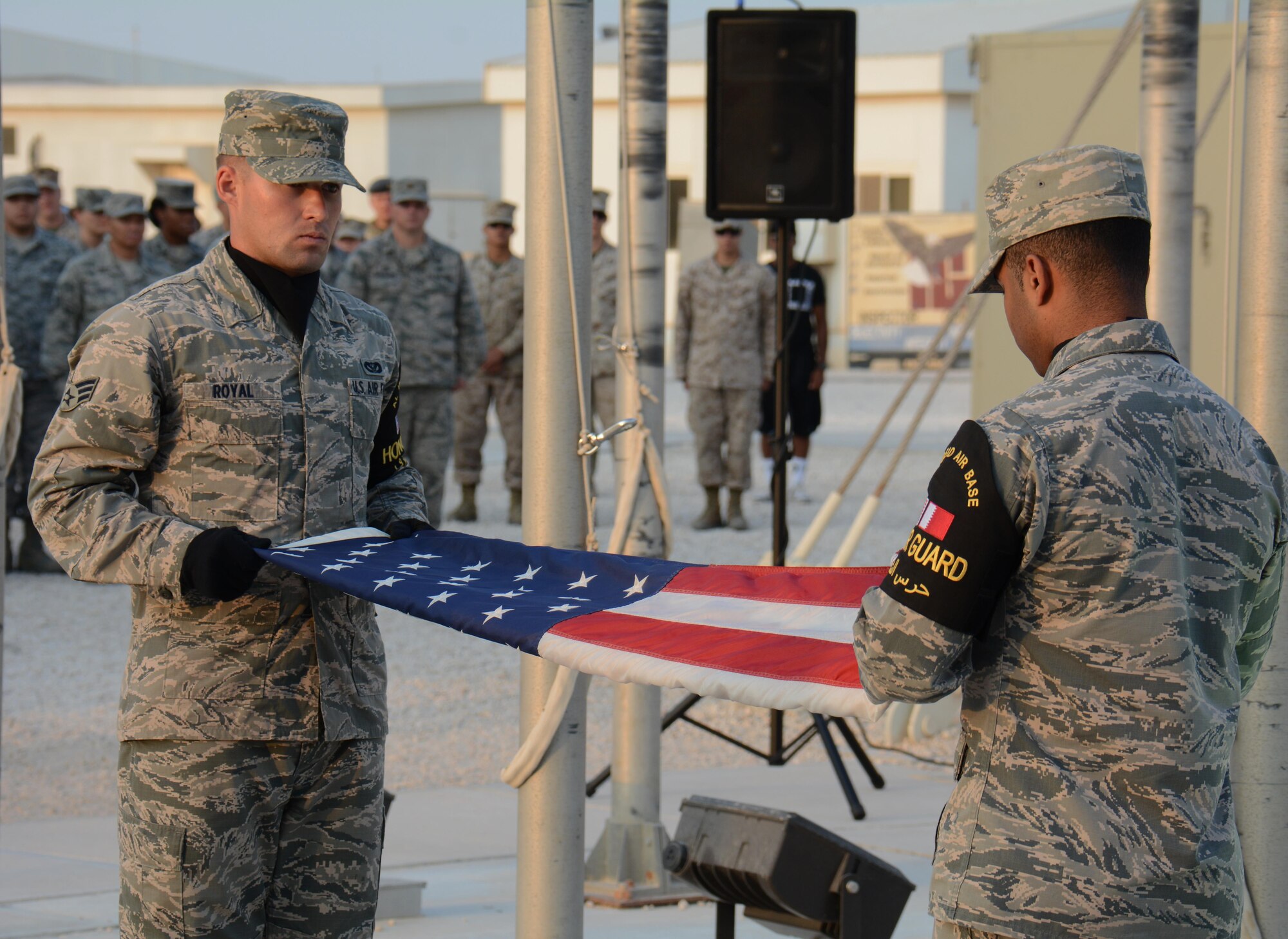 Members of the Al Udeid Air Base, Qatar Honor Guard fold the U.S. flag during a retreat ceremony at the base Nov. 11 in observance of Veterans Day. The retreat ceremony was held to honor America's veterans past and present. (U.S. Air Force photo by Tech. Sgt. James Hodgman/Released)
