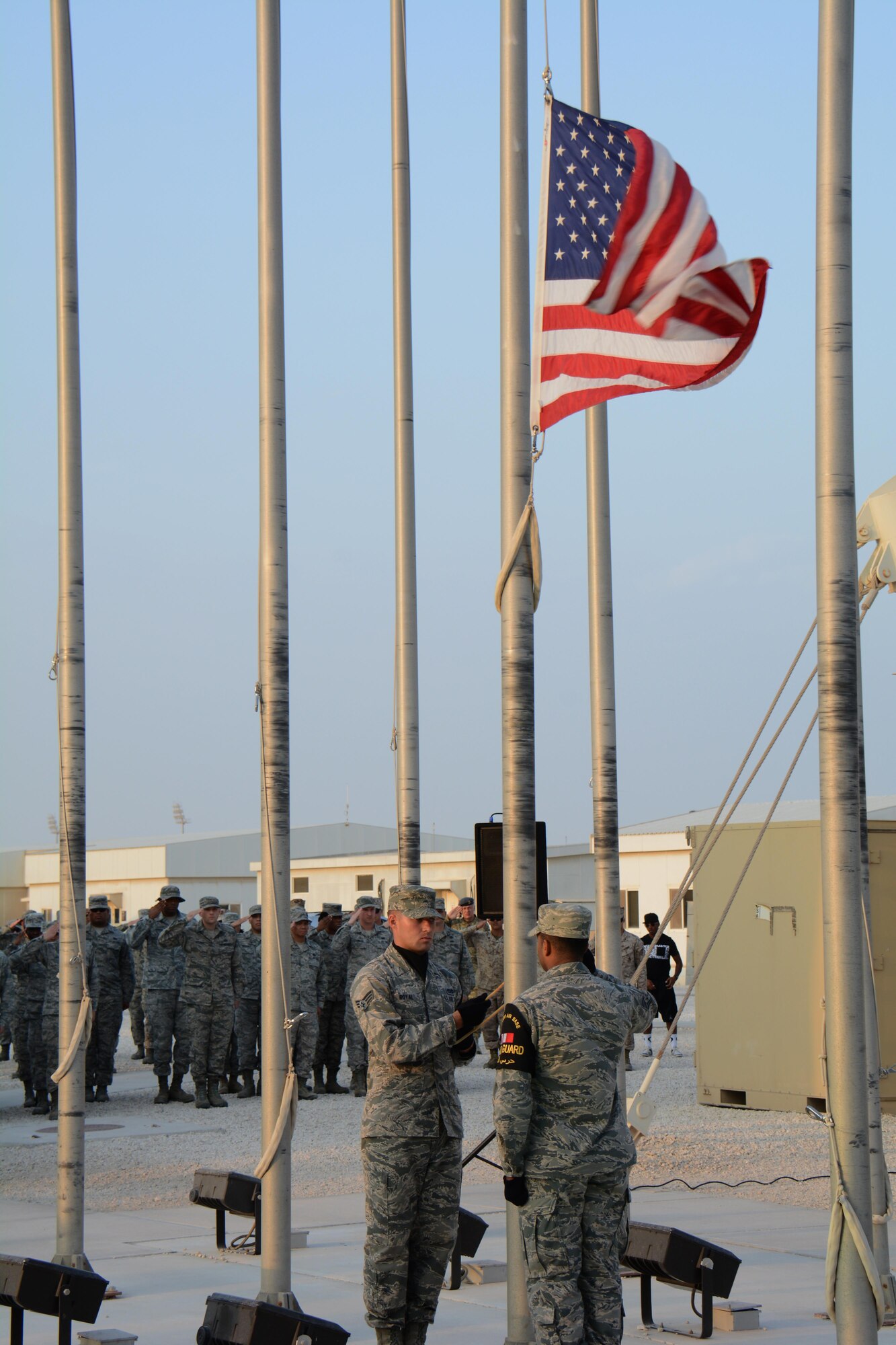 Members of the Al Udeid Air Base, Qatar Honor Guard lower the U.S. flag during a retreat ceremony at the base Nov. 11 in observance of Veterans Day. The retreat ceremony was held to honor America's veterans past and present. (U.S. Air Force photo by Tech. Sgt. James Hodgman/Released)