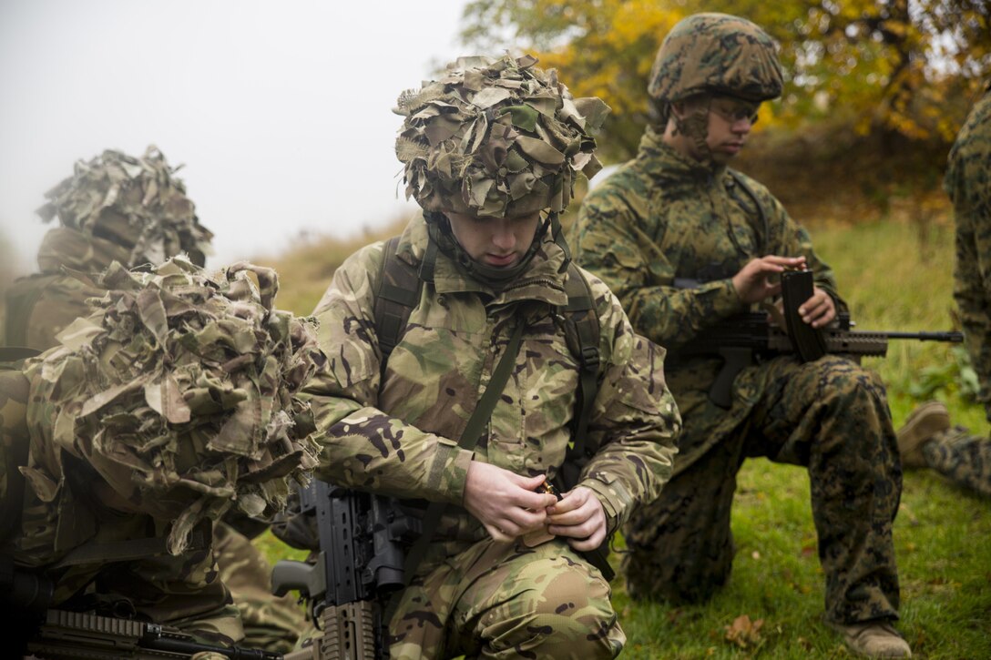 U.S. Marines with 2nd Intelligence Battalion and British soldiers load their weapons before conducting a range in Edinburgh, U.K., Nov. 4, 2015. The service members executed Exercise Phoenix Odyssey II, which combines joint intelligence and military skills training to enhance interoperability. (U.S. Marine Corps photo by Lance Cpl. Erick Galera/Released)