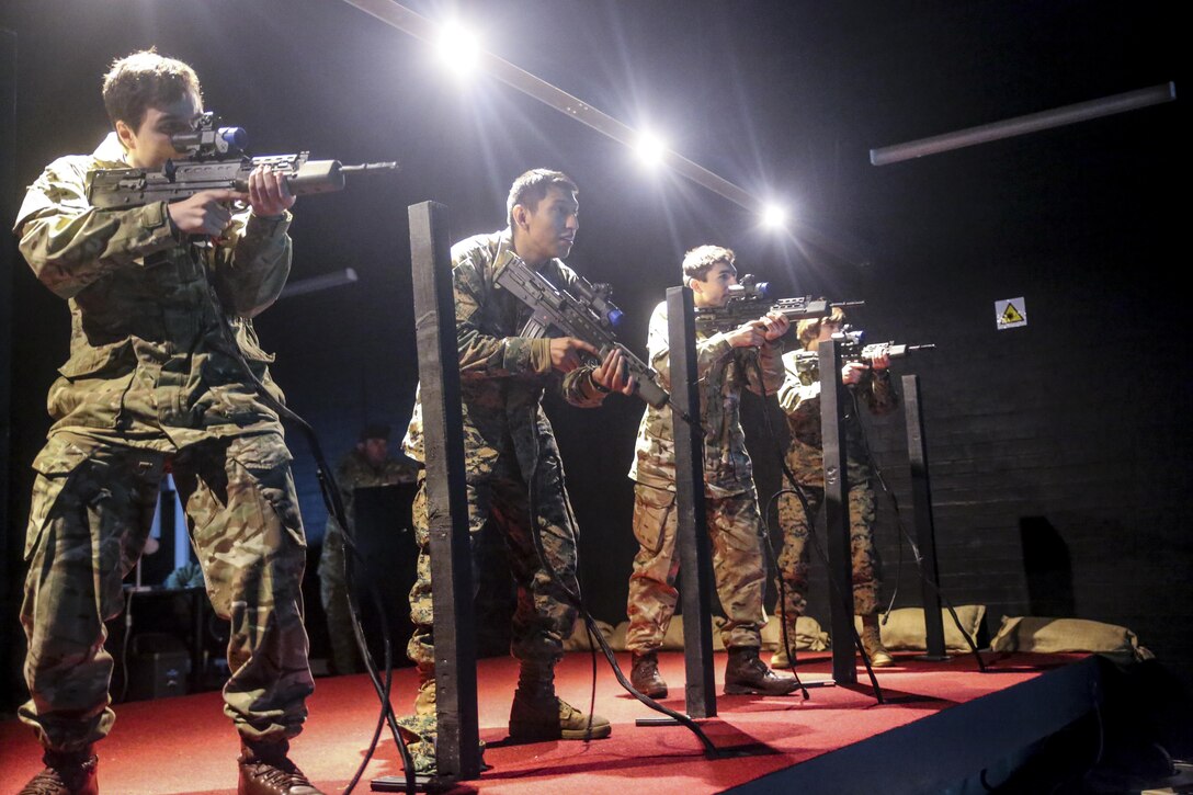 U.S. Marines with 2nd Intelligence Battalion and British soldiers rehearse combat scenarios at a Digital Combat Simulator in Edinburgh, U.K., Nov. 4, 2015. These scenarios help service members practice their shooting, communication and decision making skills to better prepare them for real life confrontations, and ultimately enhance interoperability. The forces conducted Exercise Phoenix Odyssey II which helped increase joint intelligence operations and military skills. (U.S. Marine Corps photo by Lance Cpl. Erick Galera/Released)