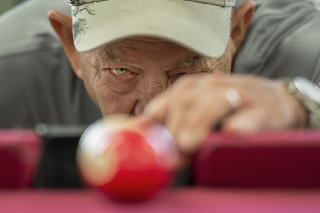 Vietnam veteran Jim Alderman lines up a shot during a game of pool in the recreation room at the inpatient post-traumatic stress disorder clinic at the Bay Pines Veterans Affairs Medical Center in Bay Pines, Fla., Oct. 30, 2015. DoD photo by EJ Hersom