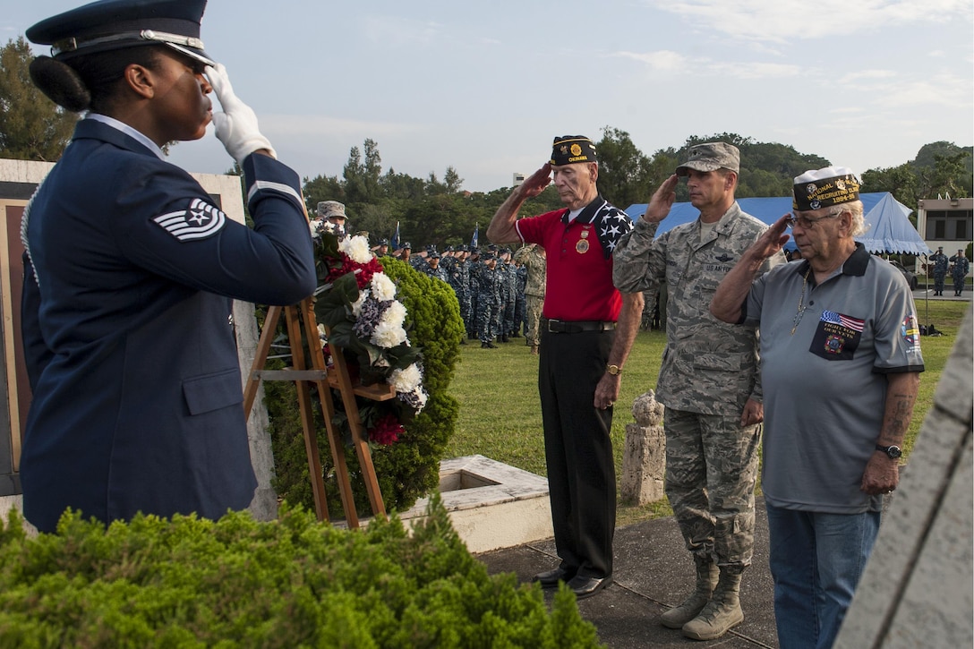 Veterans and U.S. Air Force Brig. Gen. Barry Cornish, commander of the 18th Wing, salute the Prisoner of War/Missing in Action wreath during a Veterans Day ceremony on Kadena Air Base, Japan, Nov. 11, 2015. The veterans are members of Veterans of Foreign Wars Post 9723. U.S. Air Force photo by Airman 1st Class Lynette M. Rolen