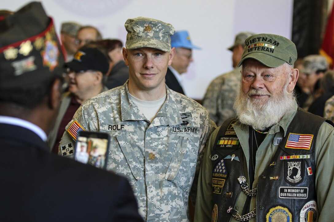 Army Maj. Zach Rolf poses for a photo with his father and Vietnam War veteran, Lynn Rolf, after the Vietnam Veterans Welcome Home Ceremony at Marshall Army Airfield on Fort Riley, Kan., Nov. 6, 2015. U.S. Army photo