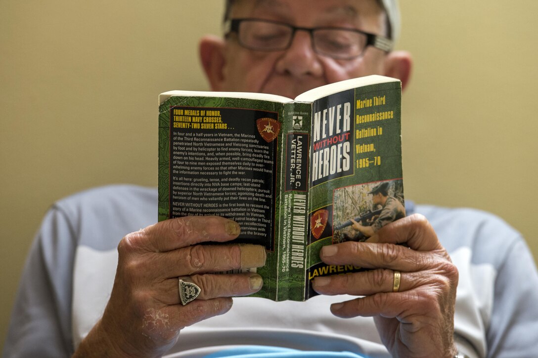 Vietnam veteran Jim Alderman reads from a book that portrays several of his actions in Vietnam at the inpatient post-traumatic stress disorder clinic at Bay Pines Veterans Affairs Medical Center in Bay Pines, Fla., Oct. 30, 2015. The book ‘Never Without Heroes,’ by Lawrence C. Vetter Jr., chronicles the Third Marine Reconnaissance Battalion in Vietnam from 1965 to 1970. DoD photo by EJ Hersom