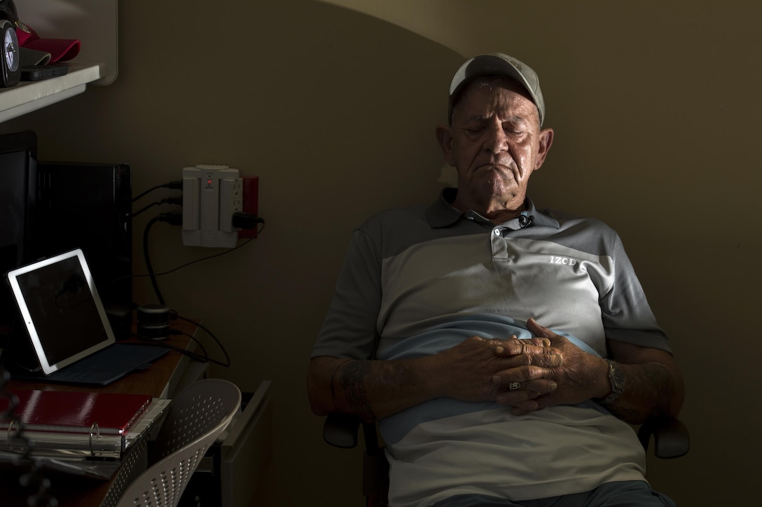 Vietnam veteran Jim Alderman listens to music playing on a portable device in his room at the inpatient post-traumatic stress disorder clinic at the Bay Pines Veterans Affairs Medical Center in Bay Pines, Fla., Oct. 30, 2015. DoD photo by EJ Hersom