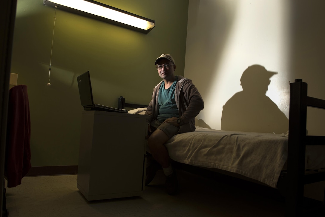 Army veteran Manuel “Al” Alcantara sits for a photo in his room at the inpatient post-traumatic stress disorder clinic at the Bay Pines Veterans Administration Healthcare Center in Bay Pines, Fla. Oct. 29, 2015. DoD photo by EJ Hersom