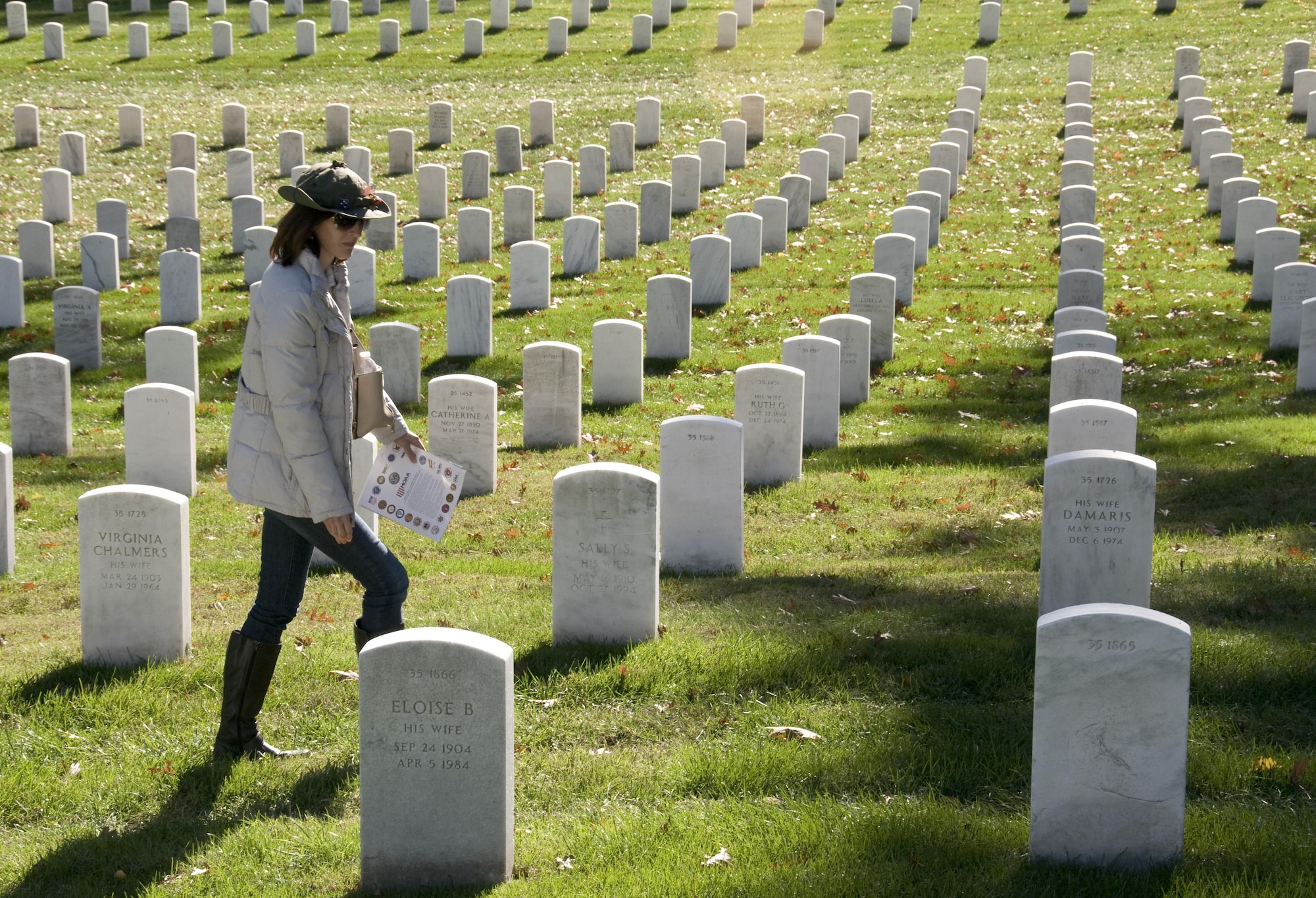 Laura Fortuna-Long reads the inscriptions on tombstones at the Arlington National Cemetery in Arlington, Va., on Nov. 11, 2015. (U.S. Air Force photo/Sean Kimmons)