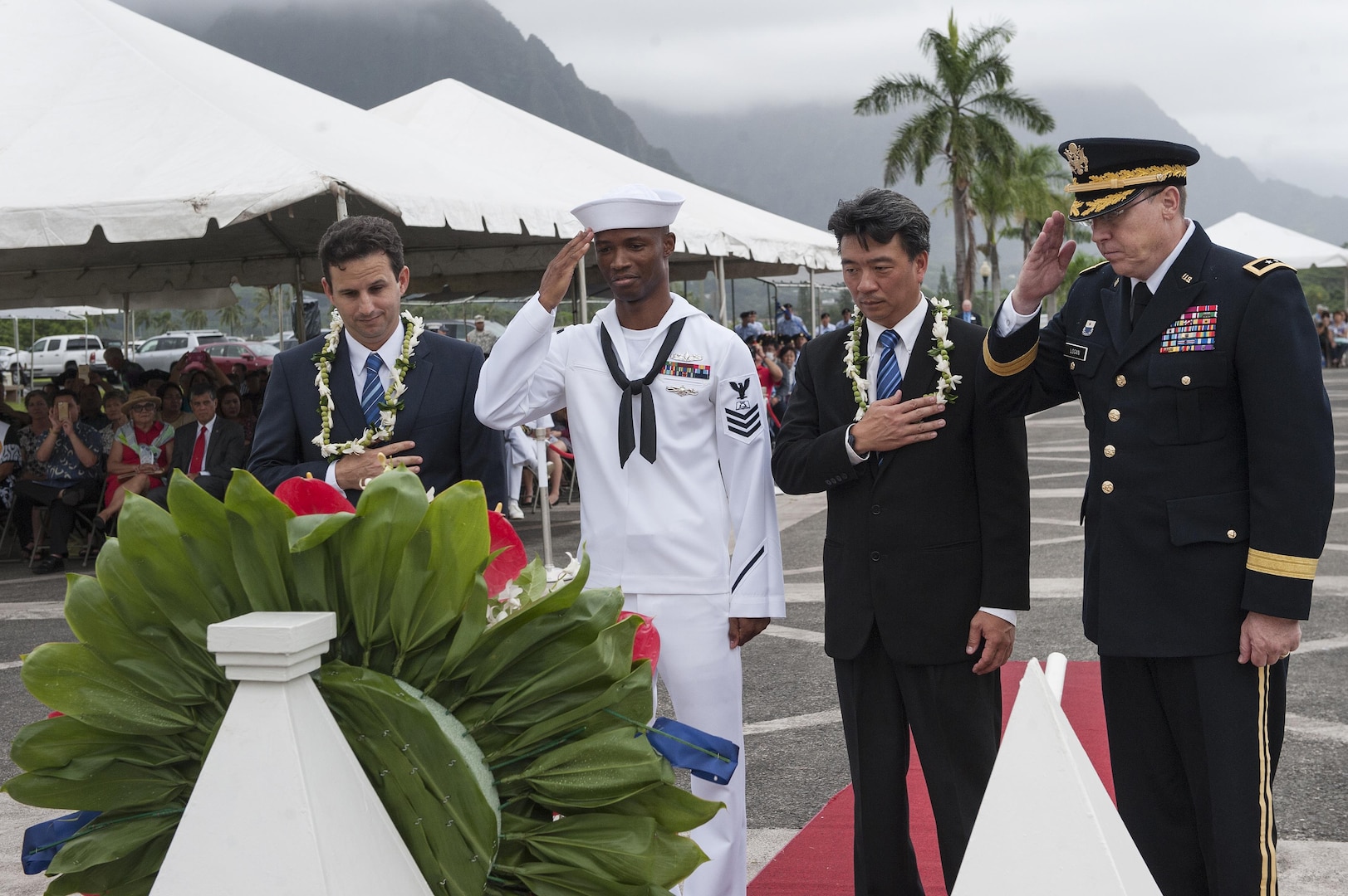 Brian Schatz (left), senior United States senator of Hawaii, Shan Tsutsui (center right), lieutenant governor of Hawaii, and U.S. Army Maj. Gen. Arthur J. Logan, the adjutant general of the state of Hawaii, render their respects alongside a U.S. Navy Sailor during a wreath laying as part of the 2015 Governor’s Veterans Day Ceremony at the Hawaii State Veterans Cemetery Nov. 11, in Kaneohe, Hawaii. U.S. Navy Adm. Harry Harris, commander of U.S. Pacific Command (PACOM), also laid a wreath with military leaders of PACOM and the U.S. Coast Guard during the ceremony. (U.S. Air Force photo by Staff Sgt. Christopher Hubenthal)