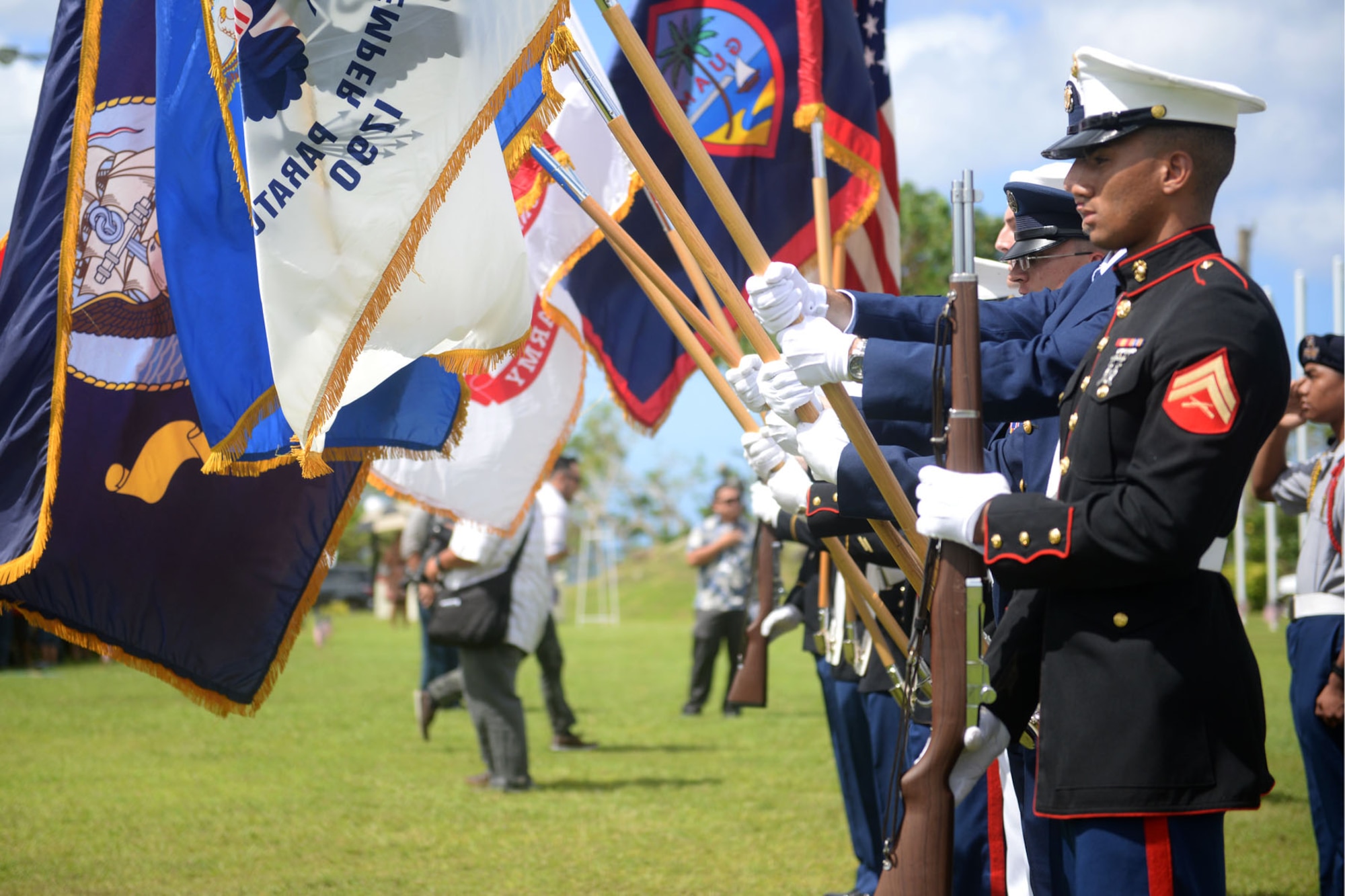 A joint service color guard presents the colors during the 2015 Veterans Day ceremony Nov. 11 in Adelup, Guam. Veterans Day honors and recognizes the personal sacrifices put forth by previous generations of servicemembers and our current servicemembers.  (U.S. Air Force photo by Senior Airman Joshua Smoot/Released)