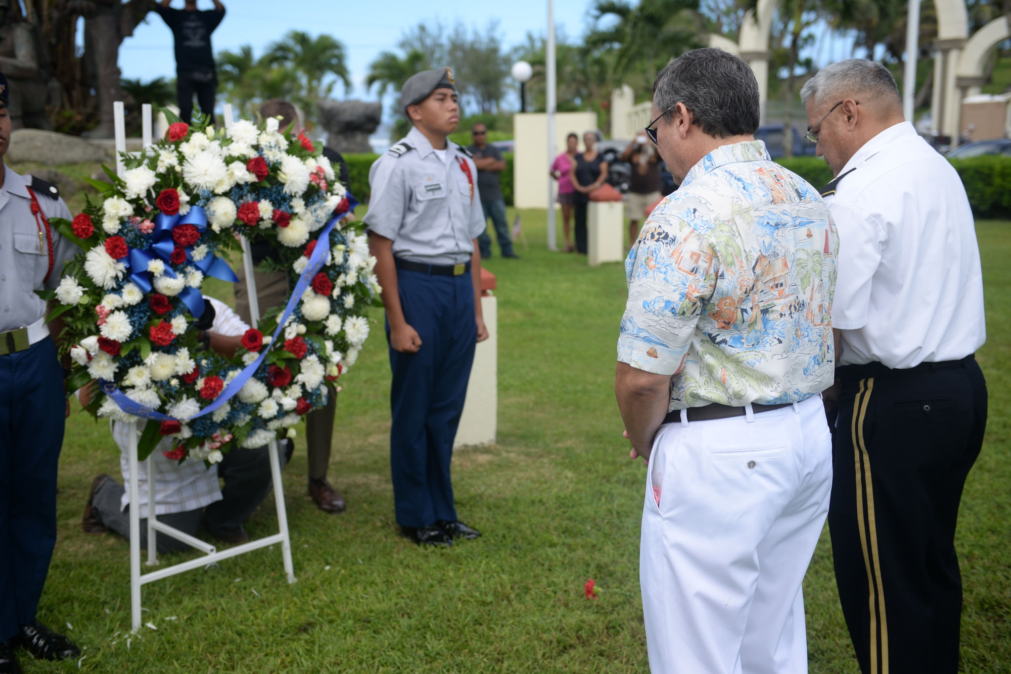 Eddie Calvo, governor of Guam, and Brig. Gen. Leon Guerrero, Guam National Guard adjutant general, pays respect to fallen veterans during the 2015 Veterans Day ceremony Nov. 11 in Adelup, Guam. Veterans Day honors and recognizes the personal sacrifices put forth by previous generations of servicemembers and our current servicemembers.  (U.S. Air Force photo by Senior Airman Joshua Smoot/Released)