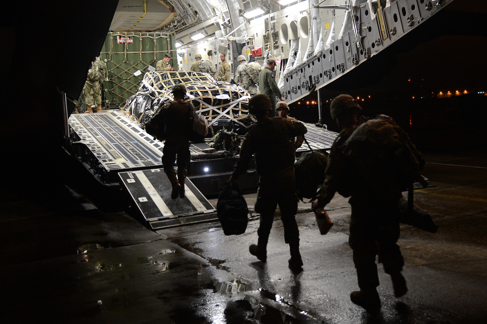 Soldiers from the 82nd Airborne Division load onto a C-17 Globemaster III Nov. 3, 2015, at Pope Army Airfield, N.C., in support of an exercise titled Ultimate Reach. Two C-17 Globemaster III airlift crews from Joint Base Lewis-McChord, Wash. flew more than 150 Paratroopers of the 82nd Airborne Division’s 2nd Brigade Combat Team across the Atlantic to conduct a joint forcible entry exercise over Zaragoza, Spain. (U.S. Air Force photo/Senior Airman Divine Cox)
