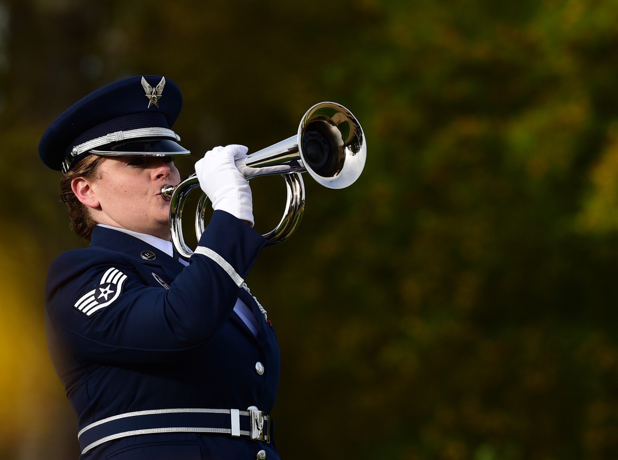 U.S. Air Force Staff Sgt. Kari Jonas, 423rd Medical Squadron public health technician, sounds TAPS during the Veterans Day ceremony at Cambridge American Cemetery, United Kingdom, Nov. 11, 2015. The ceremony honored both the 3,812 American Service members buried at the cemetery, along with veterans, past and present. (U.S. Air Force photo by Master Sgt. Chrissy Best/Released)