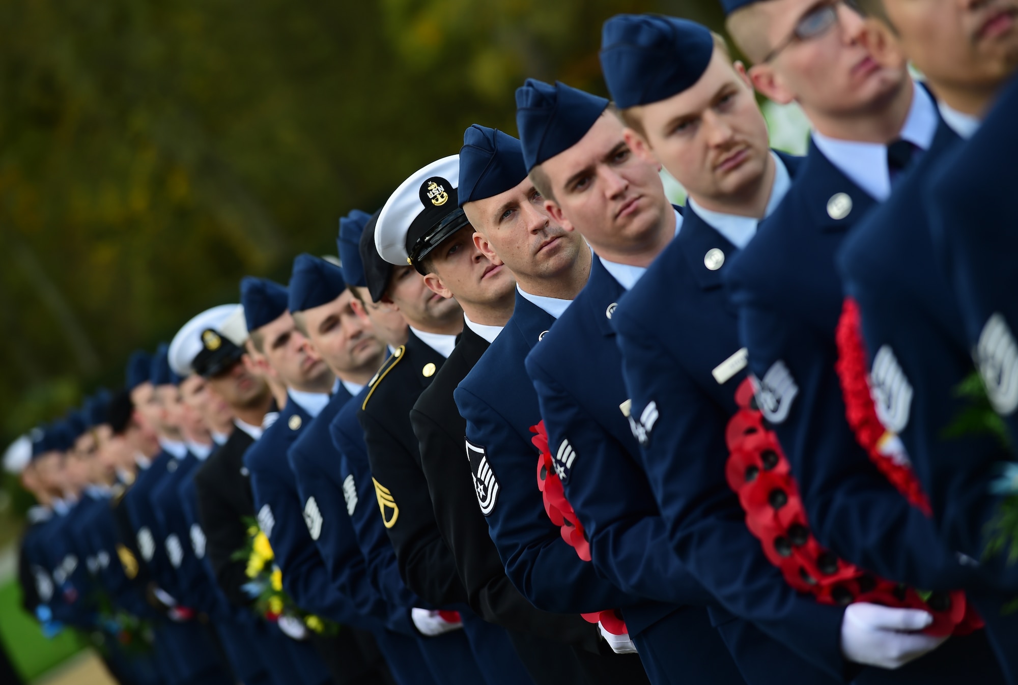 Service members from the Department of Defense, carry wreaths during the Veterans Day ceremony at Cambridge American Cemetery, United Kingdom, Nov. 11, 2015. The wreaths were laid in honor the military members past and present. (U.S. Air Force photo by Master Sgt. Chrissy Best/Released)