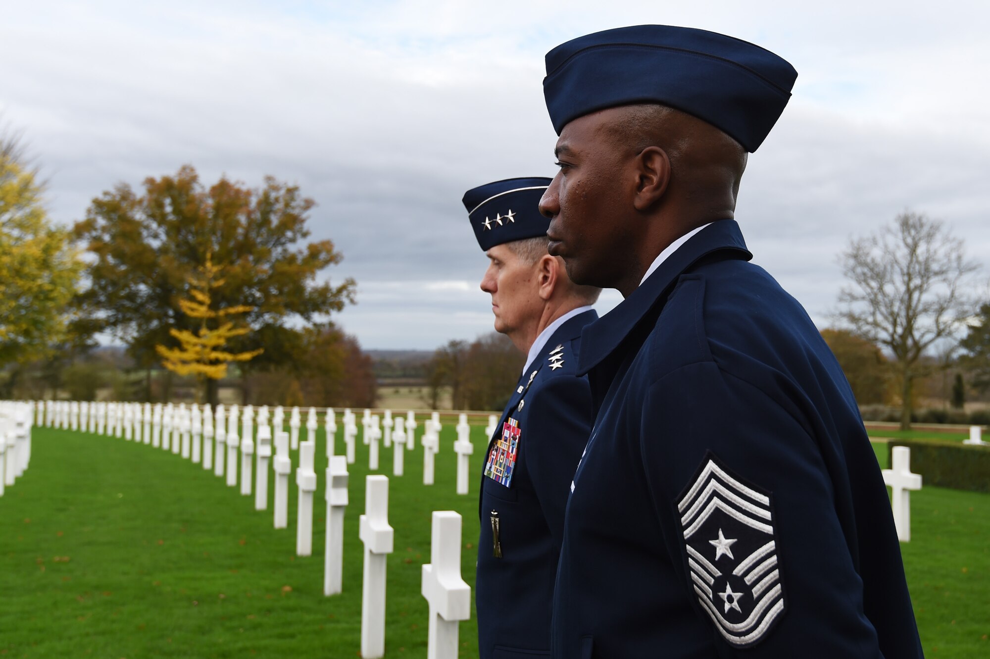 U.S. Air Force Lt. Gen. Timothy Ray, 3rd Air Force and 17th Expeditionary Air Force commander, left, and Chief Master Sgt. Kaleth Wright, 3rd AF and 17th EAF command chief, look across rows of headstones, following a Veterans Day ceremony at Cambridge American Cemetery, United Kingdom, Nov. 11, 2015. The cemetery serves as the final resting place for 3,812 American Service members killed during World War II. (U.S. Air Force photo by Staff Sgt. Jarad A. Denton/Released)