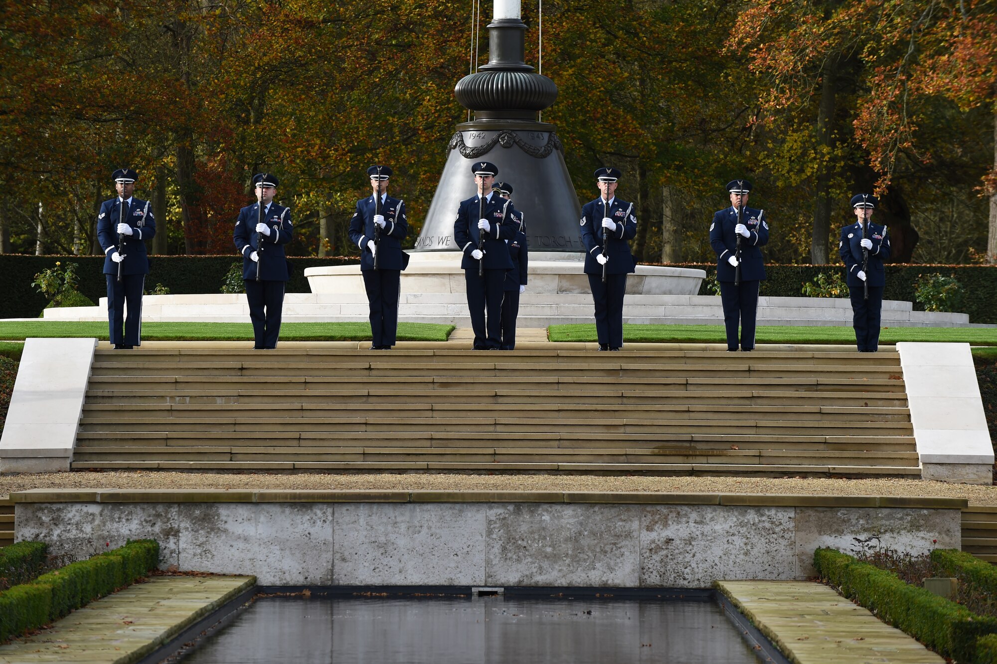 U.S. Air Force Airmen, from the 501st Combat Support Wing honor guard, present arms during a Veterans Day ceremony at Cambridge American Cemetery, United Kingdom, Nov. 11, 2015. The honor guard paid tribute to Service members both past and present with a volley and the playing of Taps. (U.S. Air Force photo by Staff Sgt. Jarad A. Denton/Released)