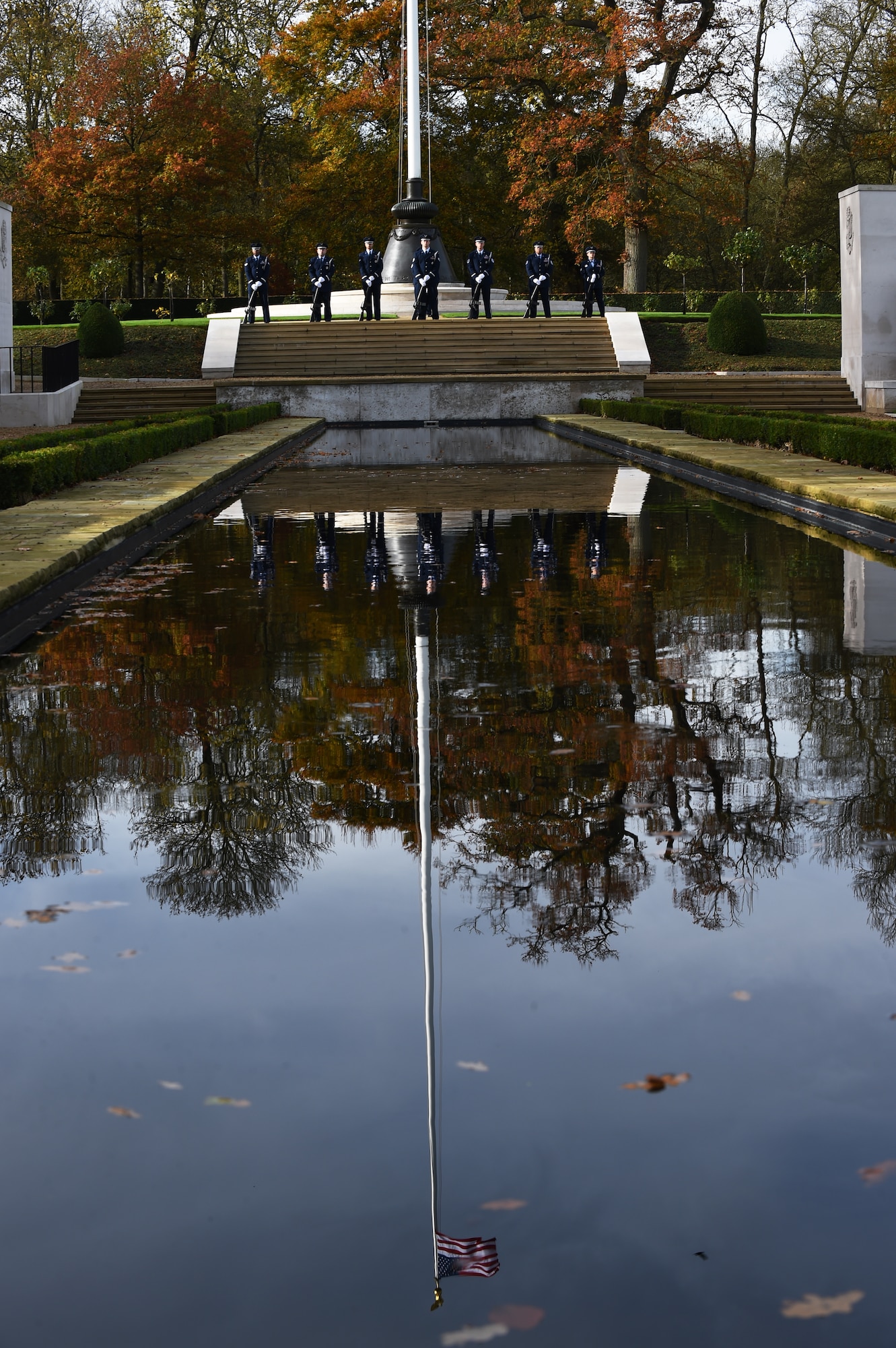 U.S. Air Force Airmen, from the 501st Combat Support Wing honor guard, stand at parade rest during a Veterans Day ceremony at Cambridge American Cemetery, United Kingdom, Nov. 11, 2015. The ceremony honored both the 3,812 American Service members buried at the cemetery, along with veterans both past and present. (U.S. Air Force photo by Staff Sgt. Jarad A. Denton/Released)