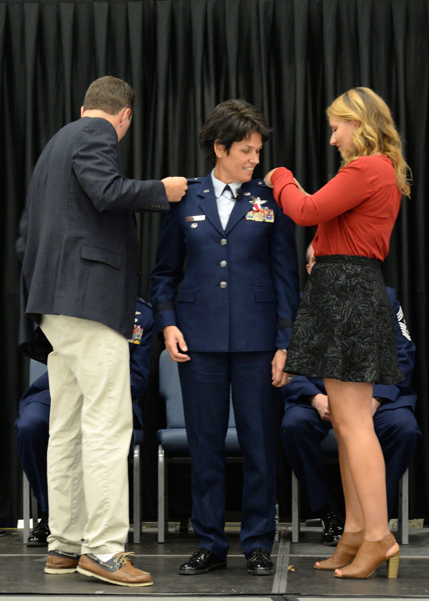 Brigadier Gen. Laurie Farris receives her new rank from her children, Drew, left, and Taylor, during a promotion ceremony at Pease Air National Guard Base, New Hampshire Nov. 7. Farris has been assigned as the N.H. ANG chief of staff responsible for the direction and coordination of staff activities for Joint Force Headquarters. (U.S. Air National Guard photo by Senior Airman Kayla McWalter) 