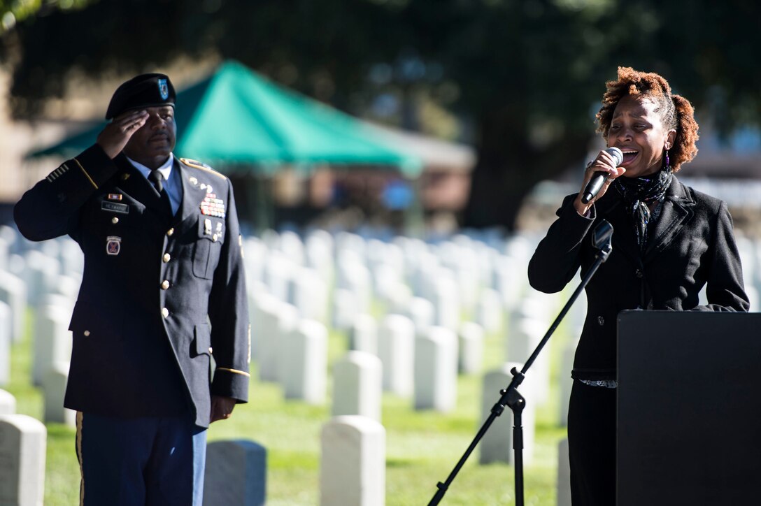 Sloane Maurice, singer, performs the national anthem during a Veterans Day Wreath Laying in Hampton, Va., Nov. 11, 2015. The ceremony was held in honor of medal of honor recipient and Civil War veteran, U.S. Army Pvt. Charles Veale. (U.S. Air Force photo by Senior Airman Kayla Newman/Released)