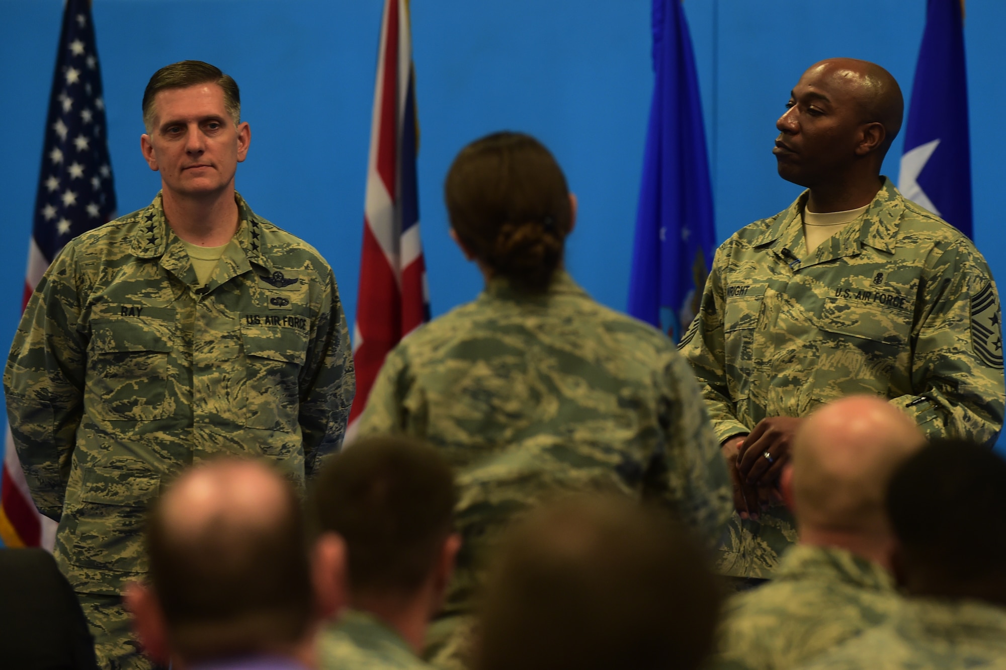 Lt. Sara Esau, the 422nd Air Base Group executive officer, asks Lt. Gen. Timothy Ray, the 3rd Air Force and 17th Expeditionary Air Force commander and Chief Master Sgt. Kaleth Wright, the 3rd Air Force and 17th Expeditionary Air Force command chief, a question during an all-call at RAF Croughton, United Kingdom, Nov. 10, 2015. During the event Ray and Wright both spoke to the Airmen about their priorities and keys to success.  (U.S. Air Force photo by Master Sgt. Chrissy Best/Released)