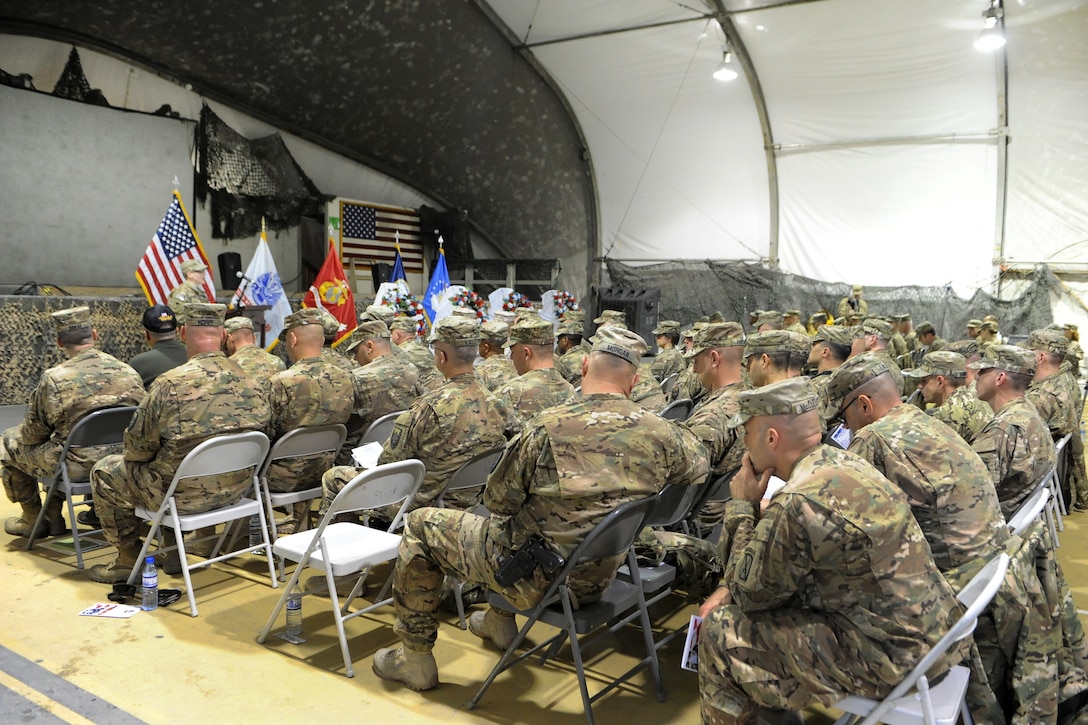 U.S. troops and civilians participate in a Veterans Day ceremony on Bagram Airfield, Afghanistan, Nov. 11, 2015. U.S. Army photo by Vanessa Villarreal