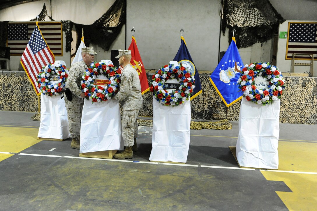 U.S. Marines lay a wreath during a Veterans Day ceremony on Bagram Airfield, Afghanistan, Nov. 11, 2015. U.S. Army photo by Vanessa Villarreal