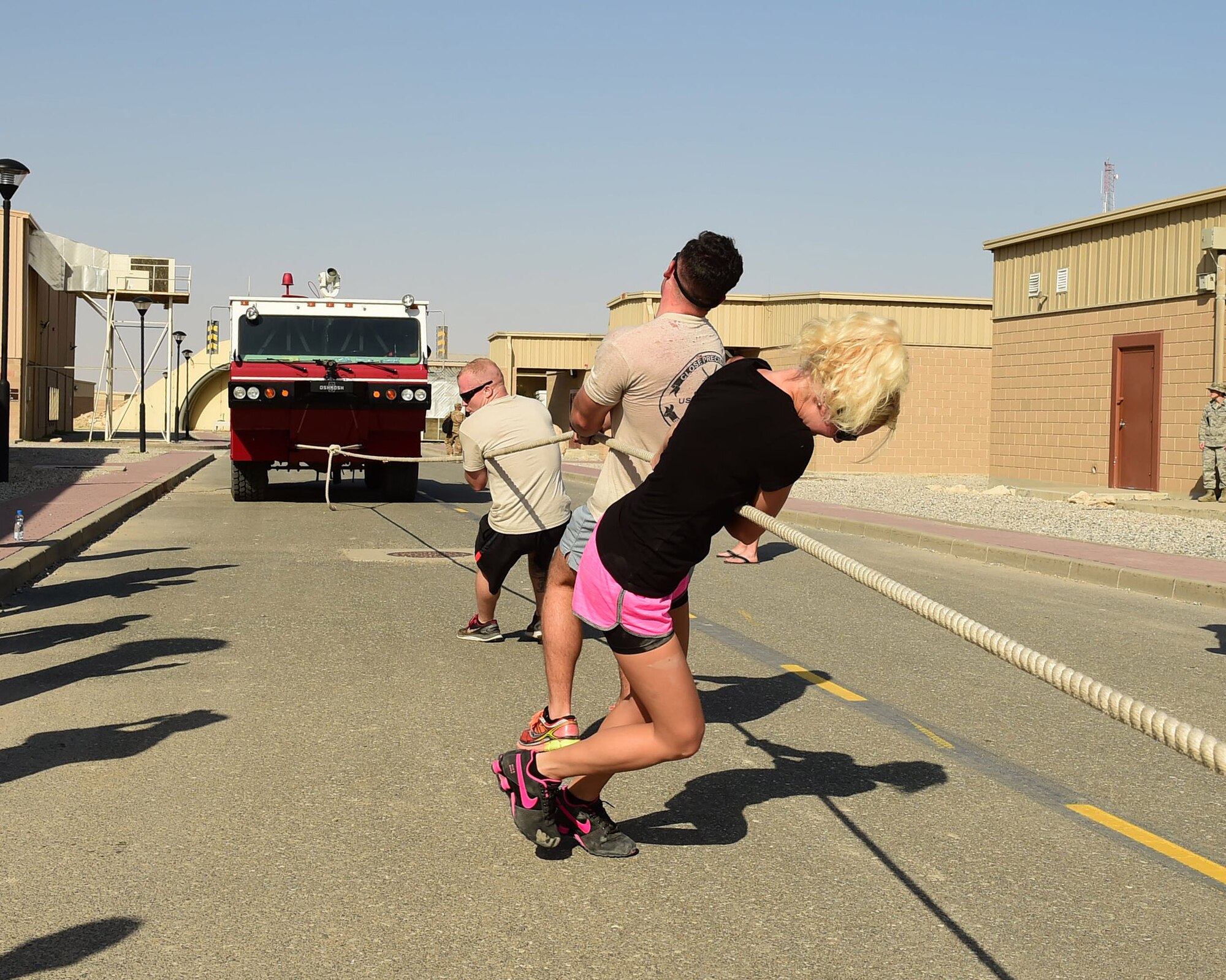 Airmen from the 387th Expeditionary Security Forces Squadron pull a firetruck as part of the first-ever Raymond Weeks’ Veteran’s Day Memorial Challenge at an undisclosed location in Southwest Asia, Nov. 11, 2015. The challenge was named after a World War II veteran who petitioned to have what was then known as Armistice Day, which honors those who lost their lives while serving in the Armed Forces, expanded to honor all Veterans. (U.S. Air Force photo by Staff Sgt. Jerilyn Quintanilla)