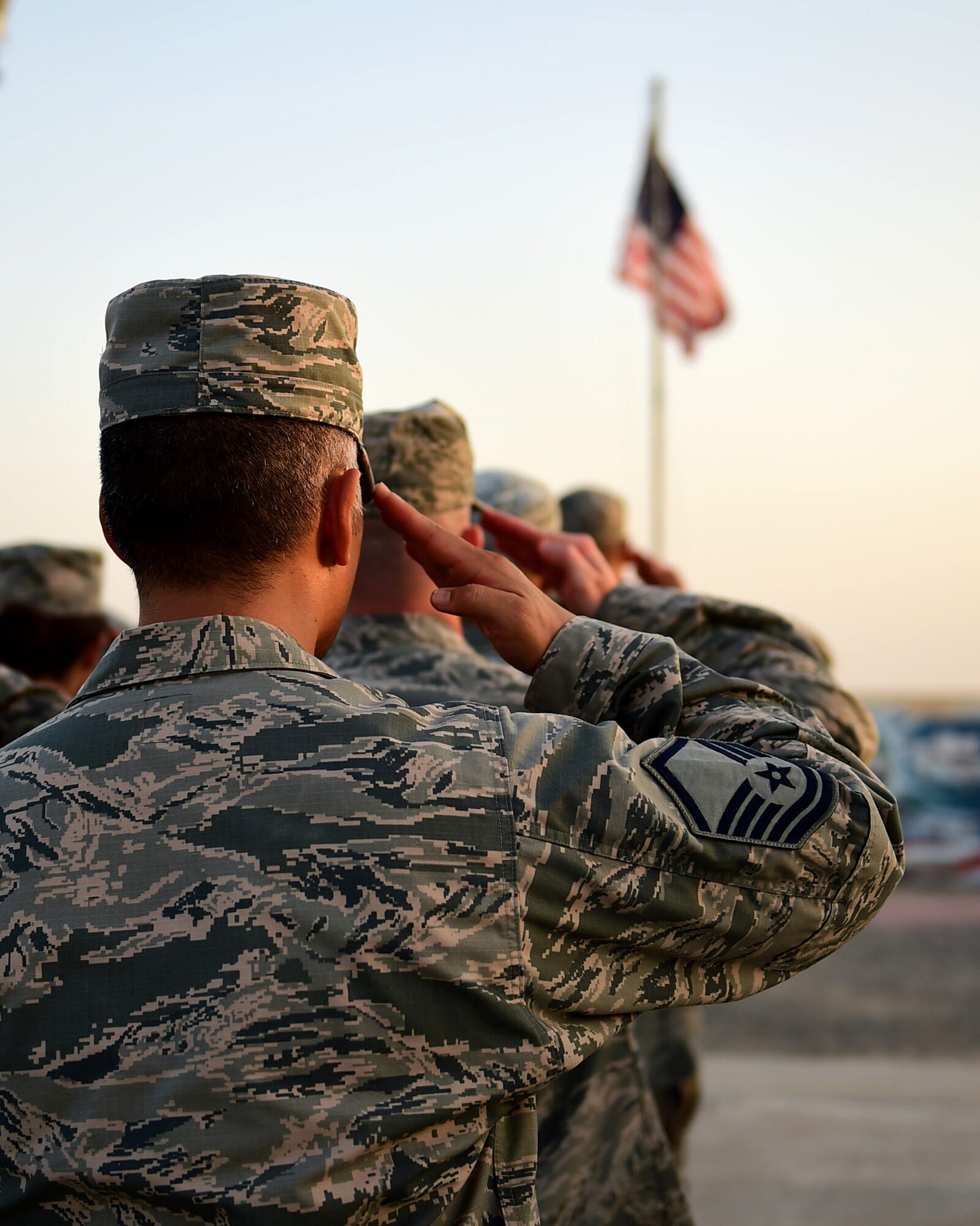 Airmen from the 386th Air Expeditionary Wing salute during the playing of the national anthem at a Veteran’s Day retreat at an undisclosed location in Southwest Asia, Nov. 11, 2015. In addition to the retreat ceremony, the 386th AEW hosted an 11K ruck march and obstacle course challenge. (U.S. Air Force photo by Staff Sgt. Jerilyn Quintanilla)