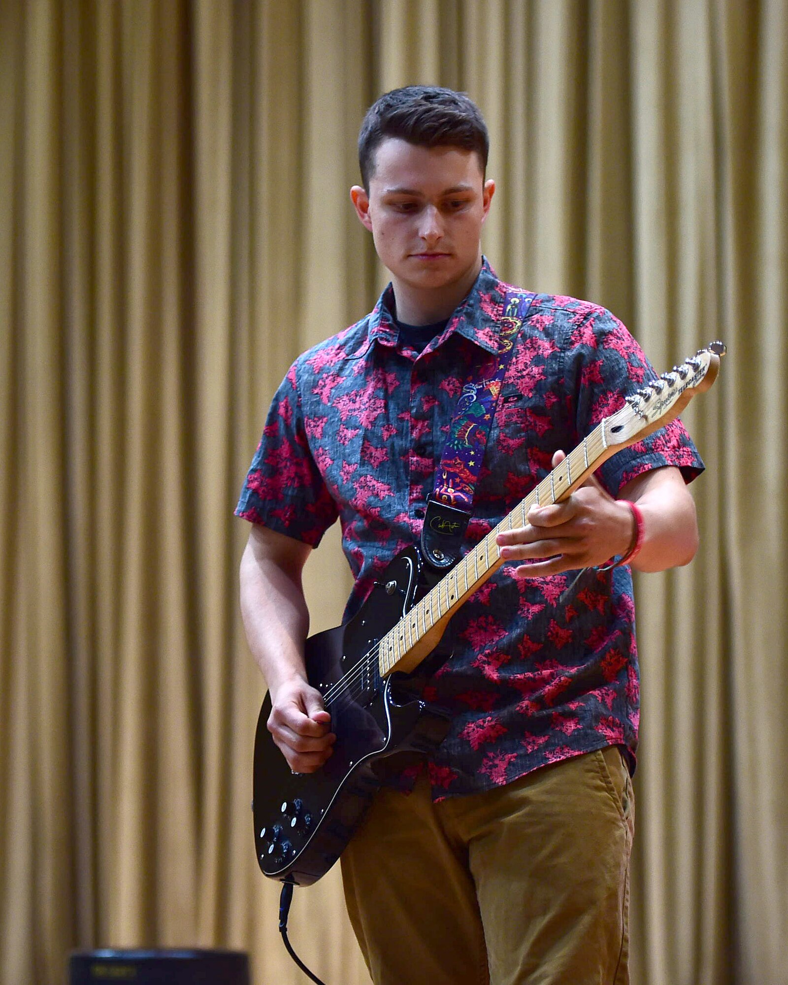 Airman Patrick Murphy, a 386th Civil Engineer Squadron firefighter, plays the national anthem during the first-ever Rock Unplugged event at an undisclosed location in Southwest Asia, Nov. 11, 2015. The 386th Air Expeditionary Wing hosted several events throughout the day including an 11K ruck march, an obstacle course challenge and a retreat ceremony. (U.S. Air Force photo by Staff Sgt. Jerilyn Quintanilla)