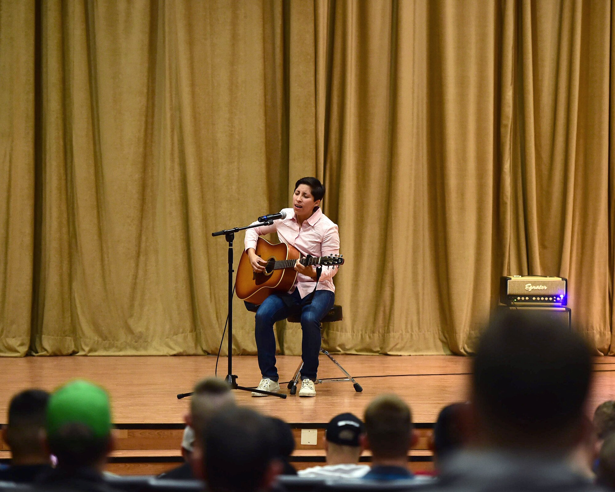 Airman 1st Class Araceli Contreras, from the 386th Civil Engineer Squadron Force Protection, performs during the first-ever Rock Unplugged event at an undisclosed location in Southwest Asia, Nov. 11, 2015. The event was one of several activities hosted by the 386th AEW in honor of Veteran’s Day. (U.S. Air Force photo by Staff Sgt. Jerilyn Quintanilla)