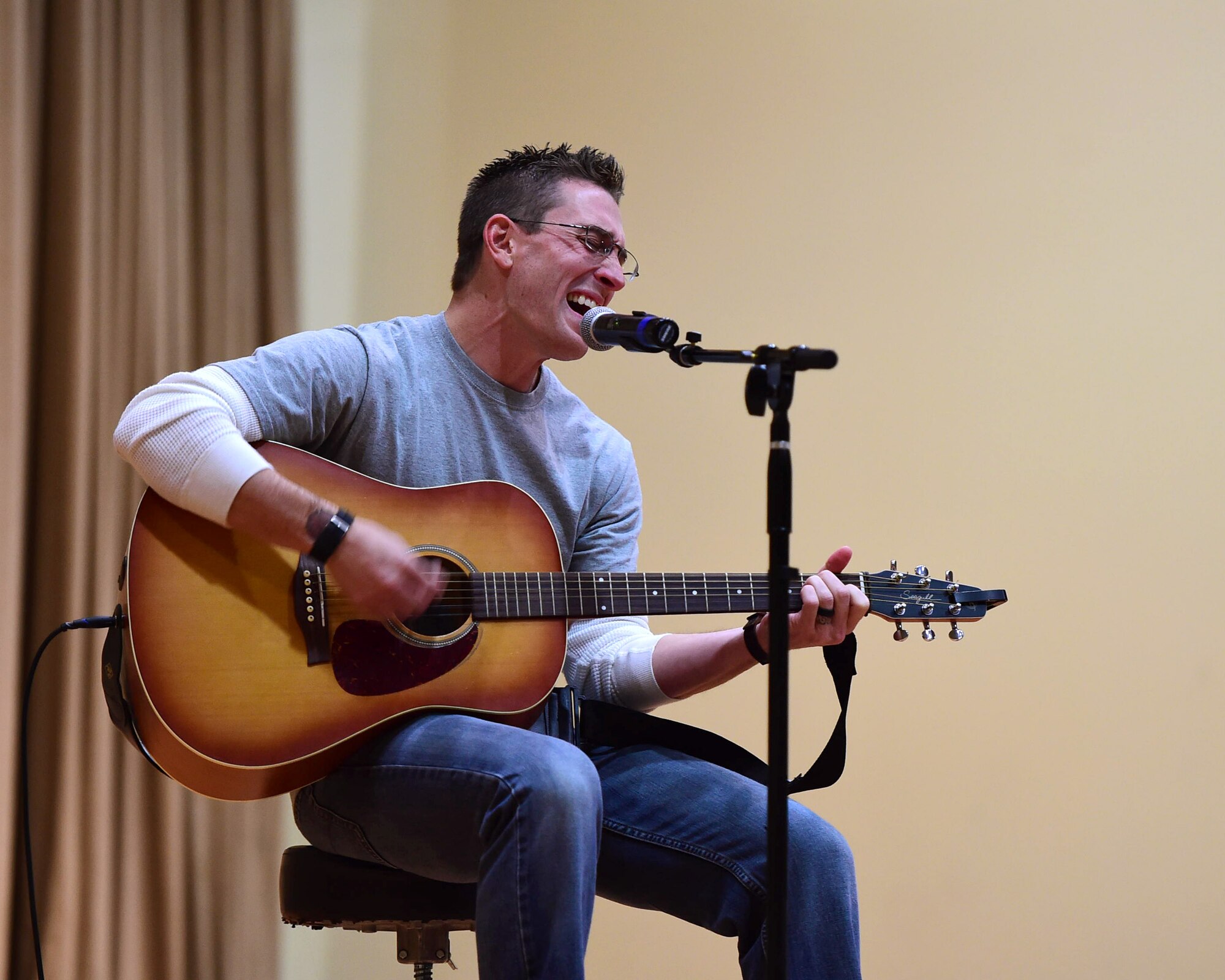 Master Sgt. Gregory Fetz, a 386th Expeditionary Civil Engineer Squadron firefighter, performs an original song during the first-ever Rock Unplugged event at an undisclosed location in Southwest Asia, Nov. 11, 2015. Fetz and two other Airmen from the 386th AEW performed during the special event held in honor of Veteran’s Day. (U.S. Air Force photo by Staff Sgt. Jerilyn Quintanilla)