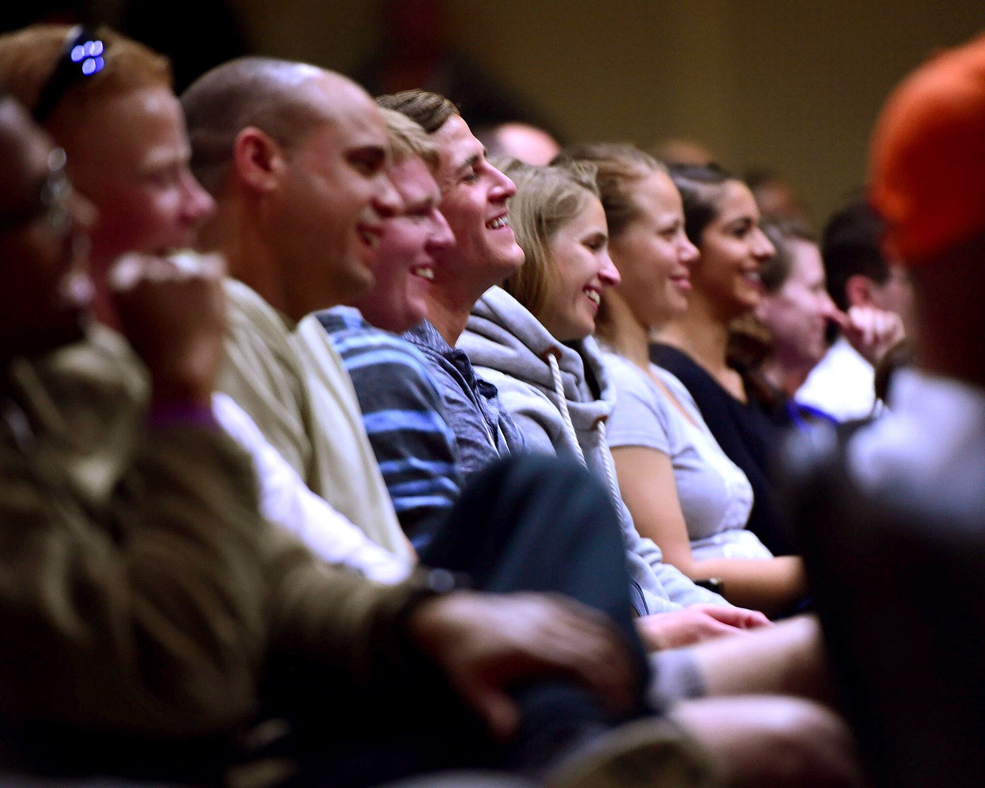 Airmen from the 386th Air Expeditionary Wing laugh during a comedy show at an undisclosed location in Southwest Asia, Nov. 11, 2015. Hosted by the 386th AEW, the show was one of several events held on base in honor of Veteran’s Day. (U.S. Air Force photo by Staff Sgt. Jerilyn Quintanilla)  