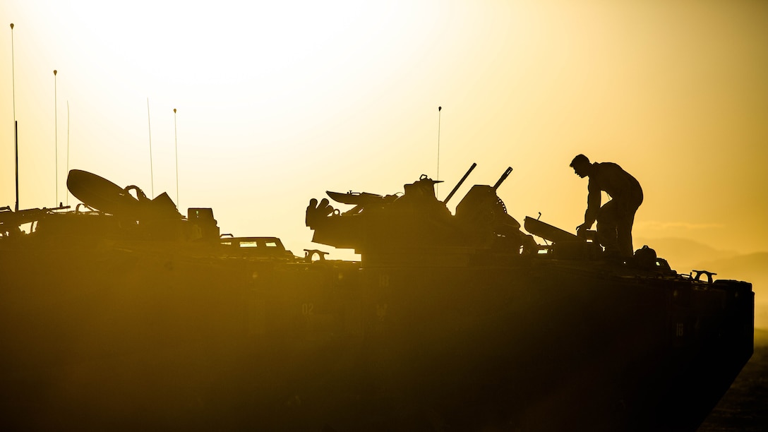 U.S. Marine Corps Lance Cpl. David B. Manktelow, a crewman with 2nd Assault Amphibian Battalion, 2nd Marine Division (MARDIV), finishes loading a M250 .50-caliber machine gun on his AAV-A1 assault amphibious vehicle before the start of a mechanized assault course during Integrated Training Exercise 1-16 aboard Marine Corps Air Ground Combat Center, Twentynine Palms, Calif., Oct. 30, 2015. Marines participate in a month-long field exercise demonstrating core mission essential tasks by conducting offensive, defensive and stability operations using combined arms, air integration, and battalion-level infantry tactics in order to strengthen operational readiness as they prepare for world-wide deployment. 