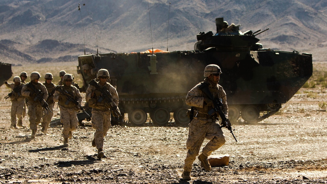 U.S. Marines with Alpha Company, 1st Battalion, 8th Marine Regiment, 2nd Marine Division, unload out of the back of an assault amphibious vehicle during Integrated Training Exercise 1-16 aboard Marine Corps Air Ground Combat Center Twentynine Palms, Calif., Oct. 30, 2015. Marines participate in a month-long field exercise demonstrating core mission essential tasks by conducting offensive, defensive and stability operations using combined arms, air integration, and battalion-level infantry tactics in order to strengthen operational readiness as they prepare for world-wide deployment. 