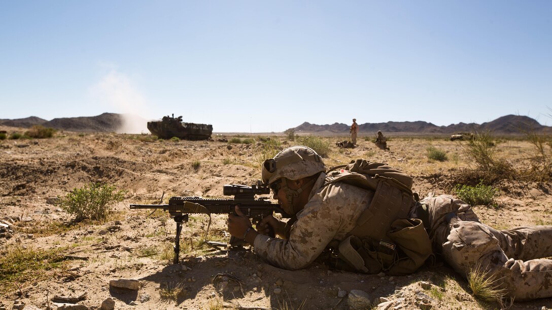 A U.S. Marine Corps rifleman with Alpha Company, 1st Battalion, 8th Marine Regiment, 2nd Marine Division, fires rounds at an enemy as his fire team prepares to push towards their next objective in a mechanized assault course during Integrated Training Exercise 1-16 aboard Marine Corps Air Ground Combat Center Twentynine Palms, Calif., Oct. 30, 2015. Marines participate in a month-long field exercise demonstrating core mission essential tasks by conducting offensive, defensive and stability operations using combined arms, air integration, and battalion-level infantry tactics in order to strengthen operational readiness as they prepare for world-wide deployment.