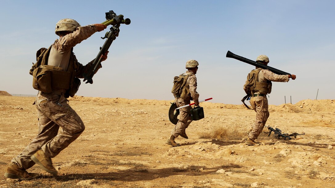 U.S. Marines with Weapons Company, 1st Battalion, 7th Marine Regiment, Special Purpose Marine Air-Ground Task Force--Crisis Response--Central Command, rush with their weapons system as they conduct live-fire training on the new M252A2 81mm mortar system at Al Asad Air Base, Iraq, Oct. 24, 2015.  The training allowed the Marines, who are charged with providing security of Al Asad, an opportunity to hone their tactics, techniques and procedures in employment of the system, further reinforcing their ability to provide protection to their coalition and Iraqi Security Force partners as part of the Combined Joint Task Force – Operation Inherent Resolve’s building partner capacity mission.