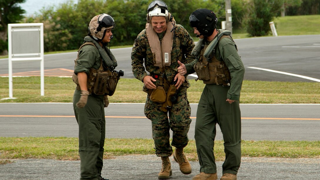 Lt. Gen. Michael G. Dana, center, prepares to board a UH-1Y Huey helicopter for an air tour Nov. 5 on Camp Courtney, Okinawa, Japan. The air tour allowed Dana to view strategic access points on Okinawa, as well as the strategic resources and high readiness of Marine Corps Installations Pacific camps and facilities in daily support of operations across the Indo-Asia-Pacific region. The visit also drew attention to the importance of financial and manpower resources within MCIPAC. Dana is the deputy commandant for installations and logistics.